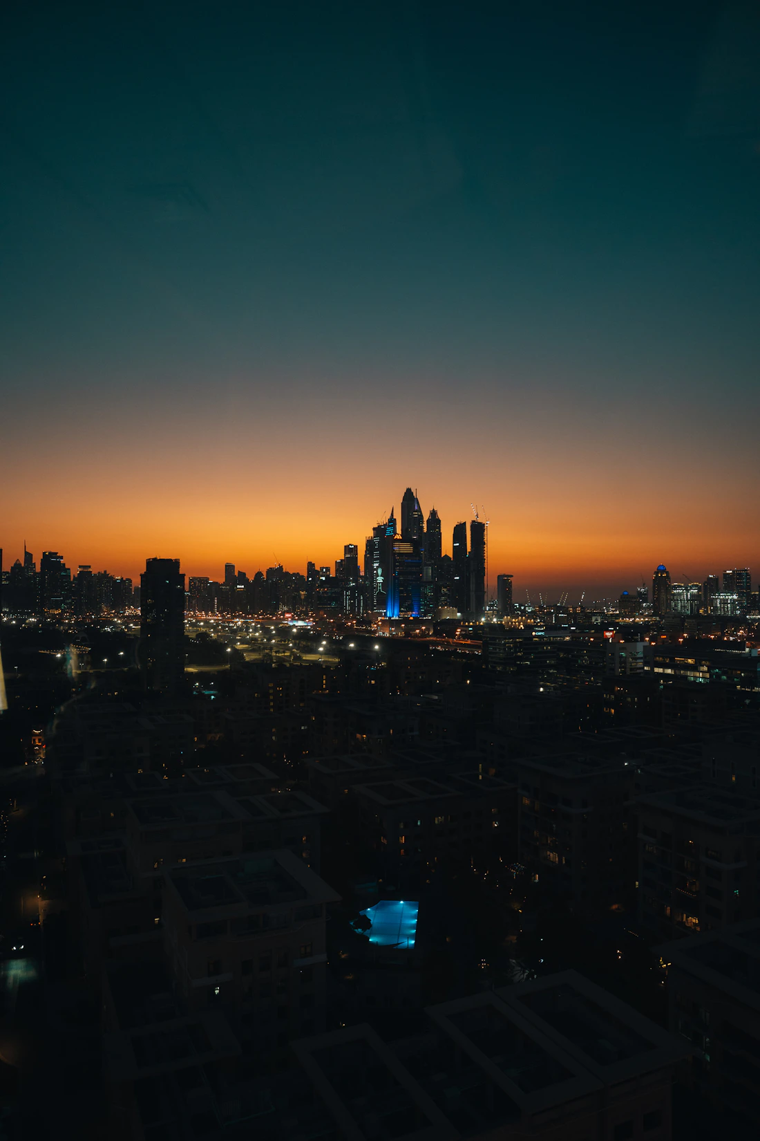 Dubai skyline lit up at sunset