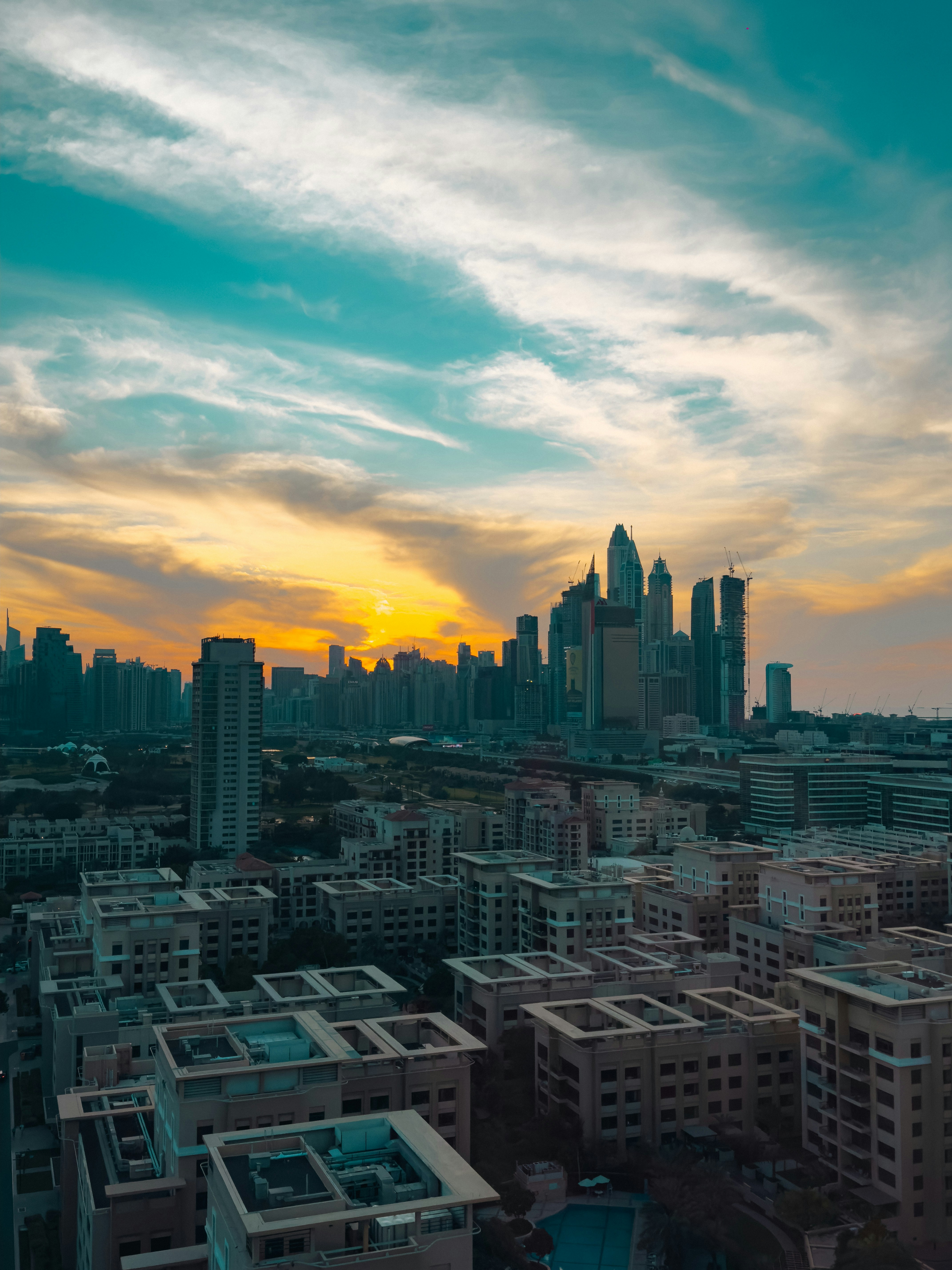 City skyline at sunset with dramatic clouds