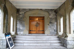 Stone building with grand wooden double doors