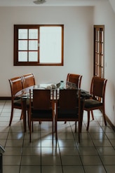 A wooden dining table with chairs in a room