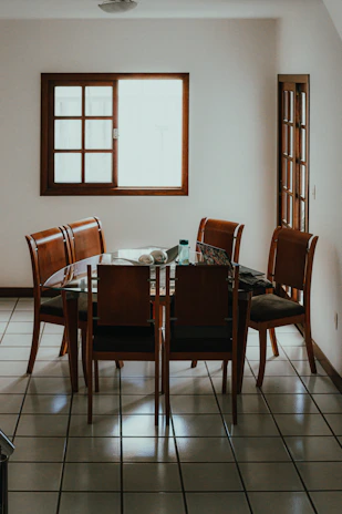 A wooden dining table with chairs in a room