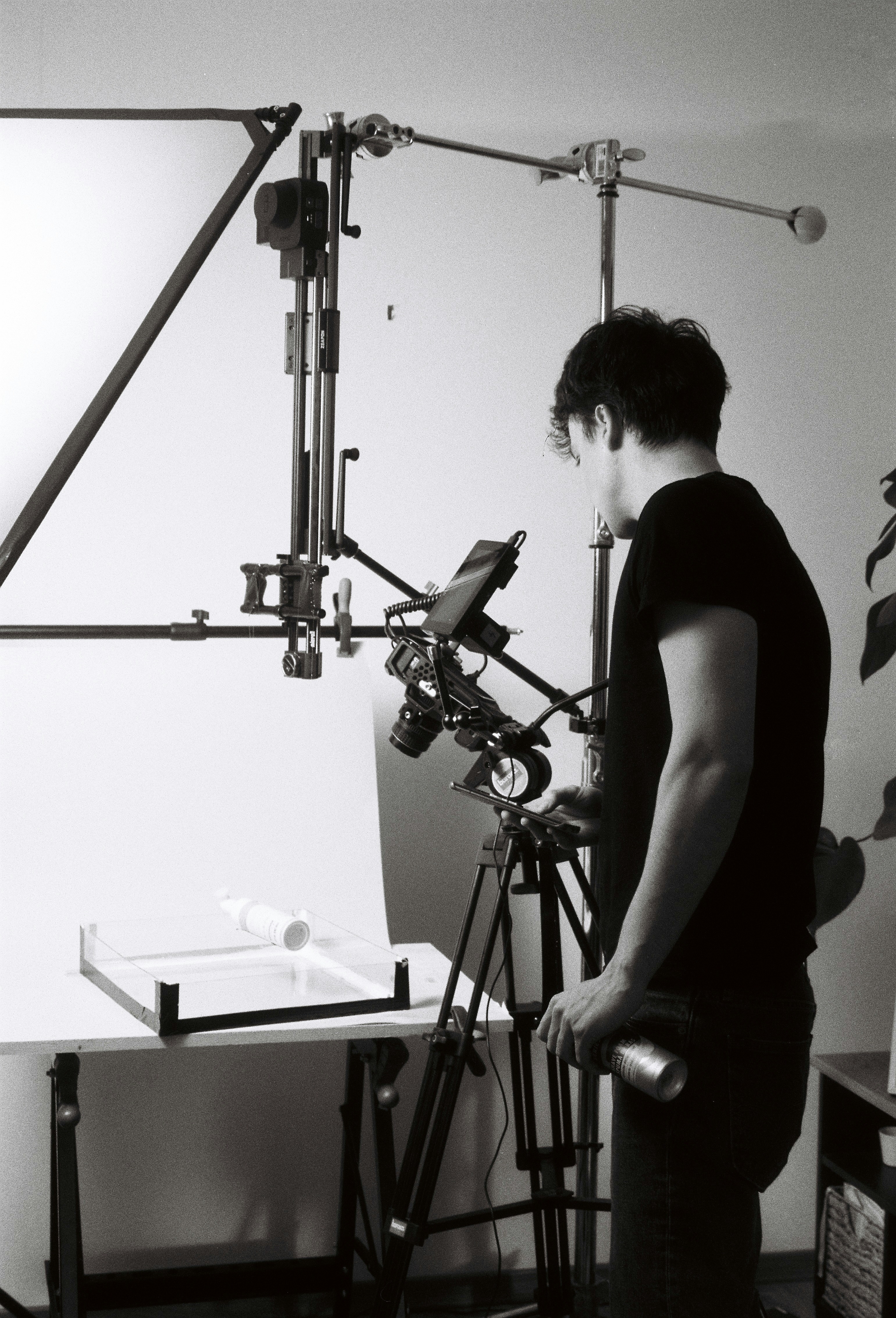 Man setting up studio lighting for product photography.