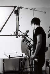 Man setting up studio lighting for product photography.