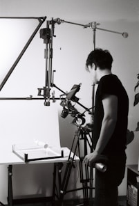 Man setting up studio lighting for product photography.
