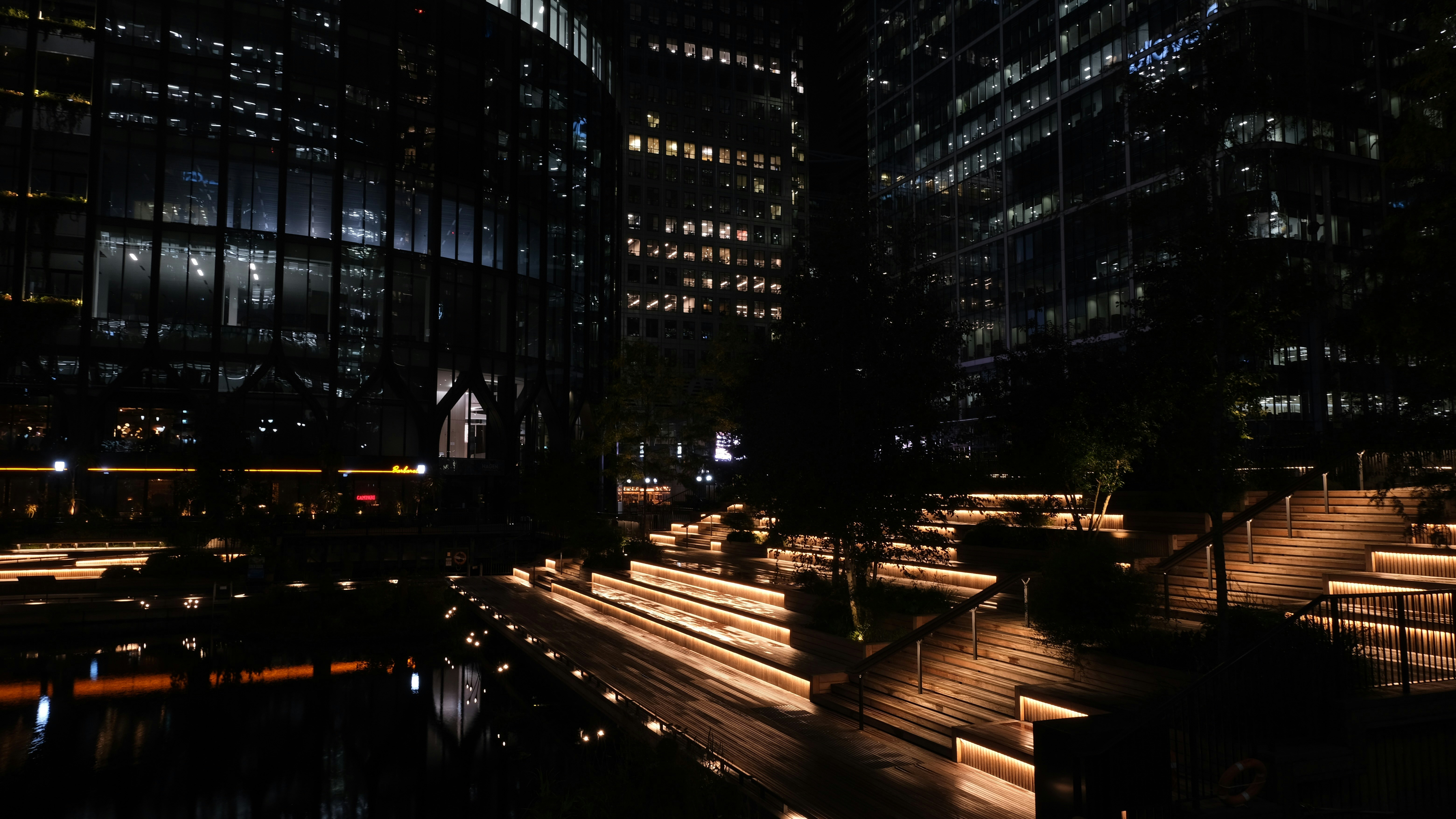 夜の照明に灯る建物が特徴の現代的な都市景観。