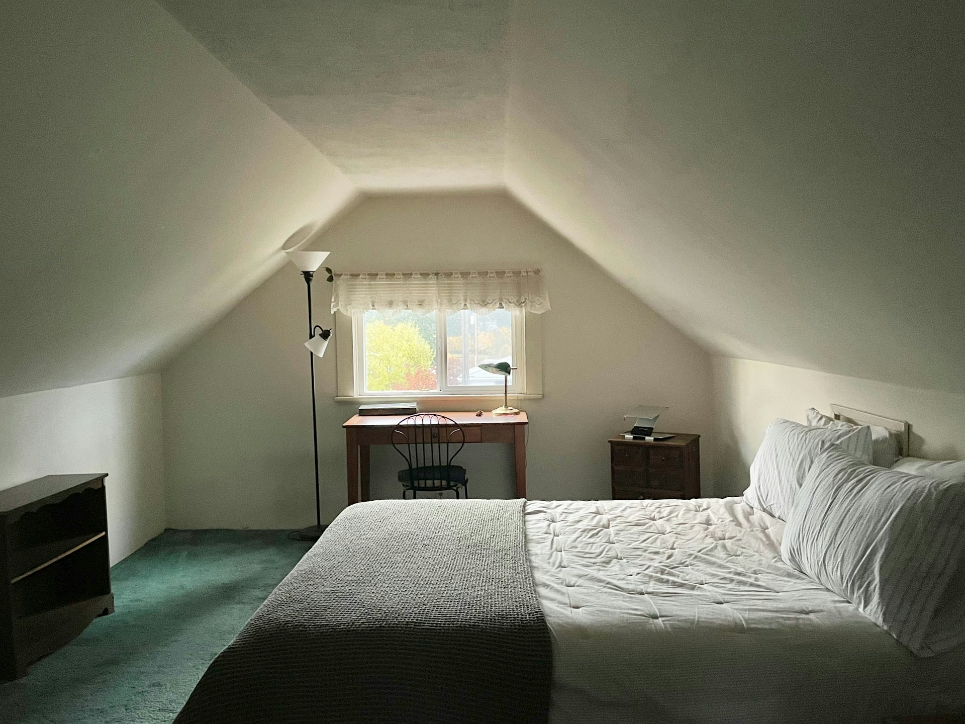 Attic bedroom with a bed and window