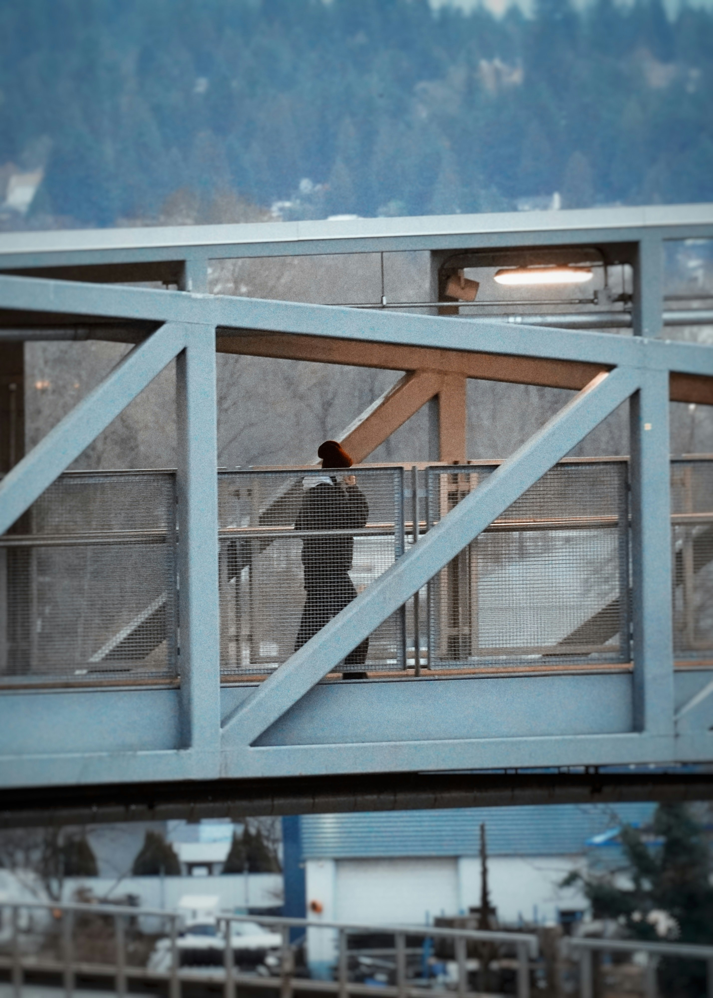 Person walking on a modern pedestrian bridge.