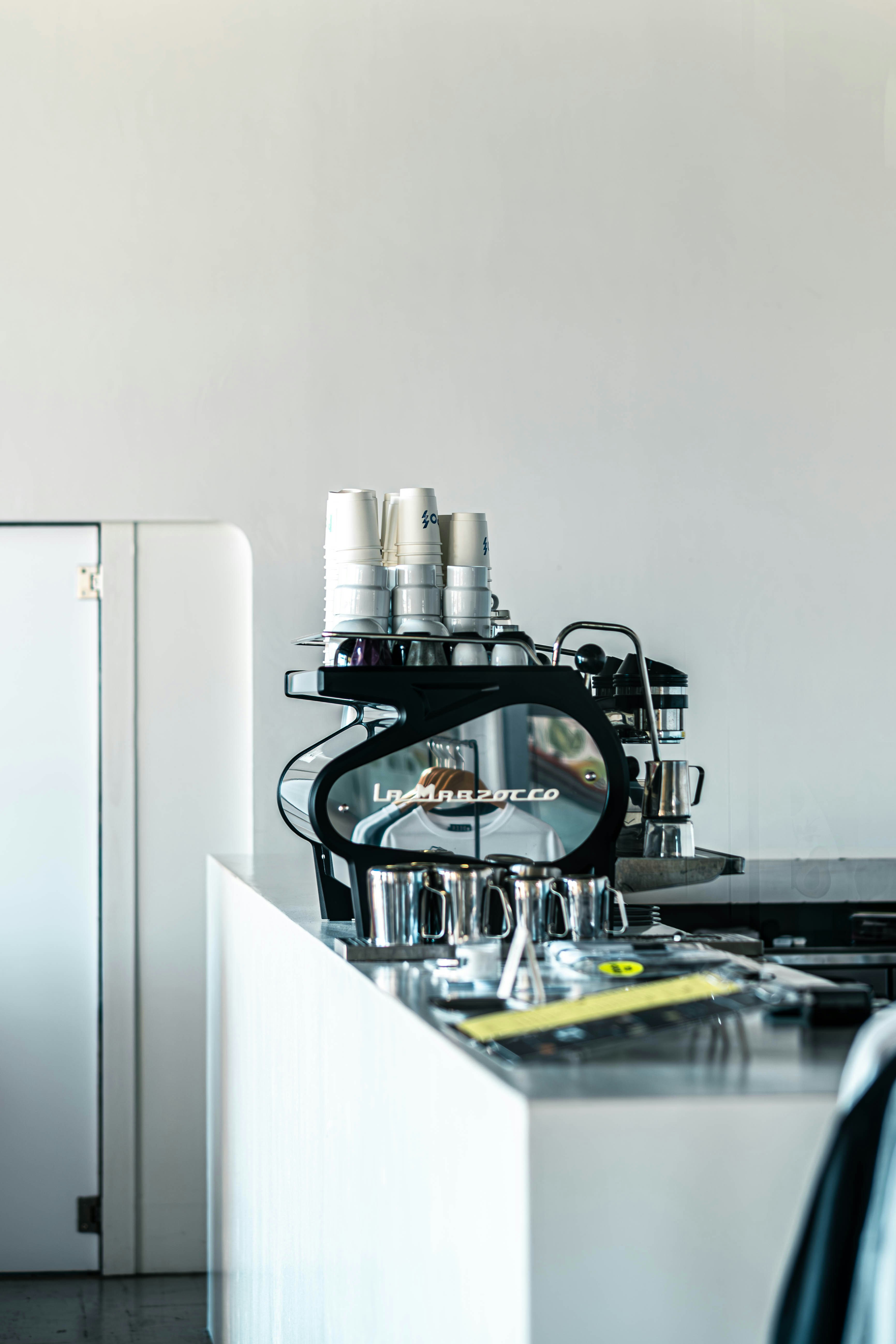 Espresso machine with stacked cups on counter