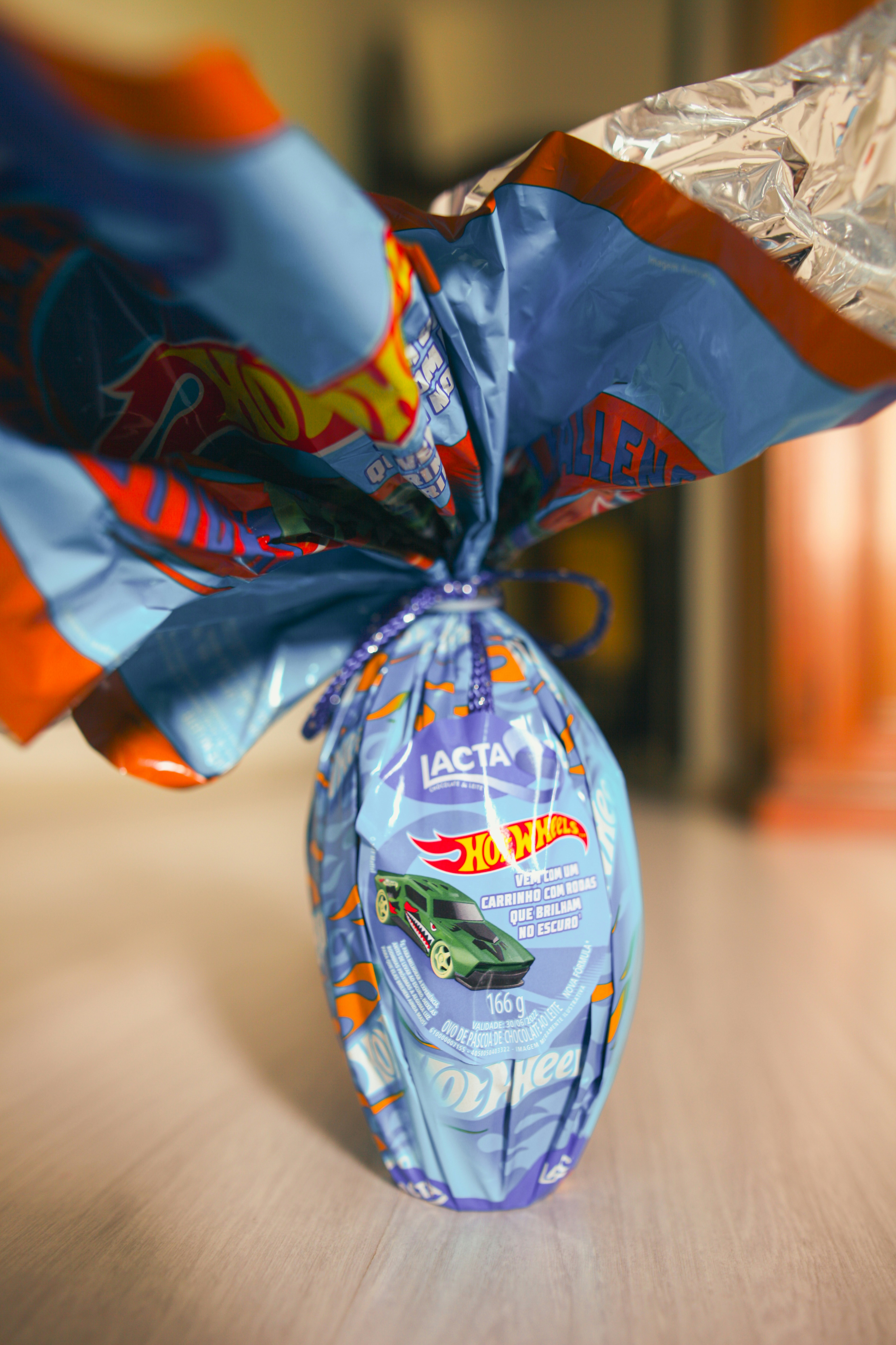 Hot wheels themed easter egg wrapped in blue foil.