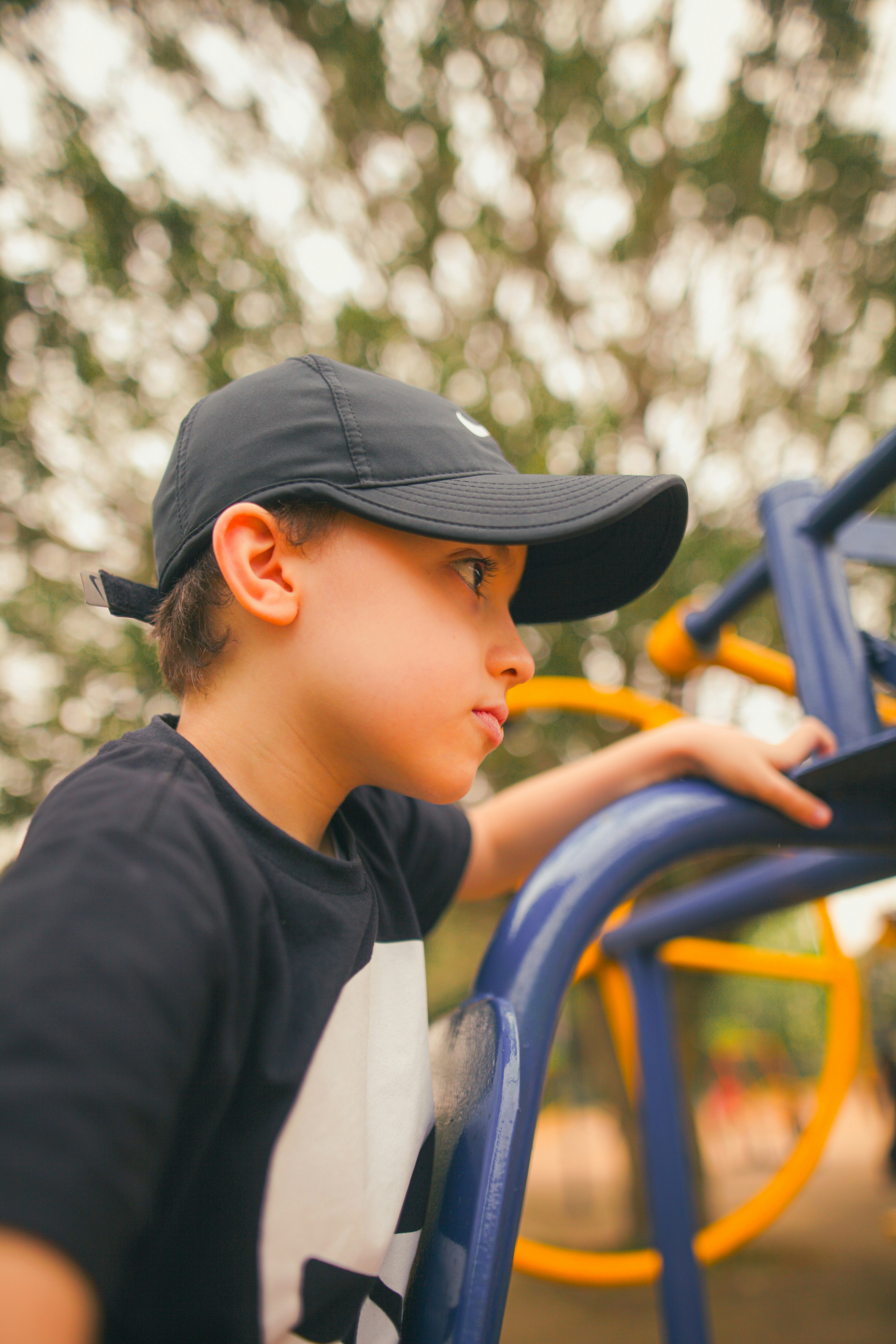 Young boy in a baseball cap at a playground