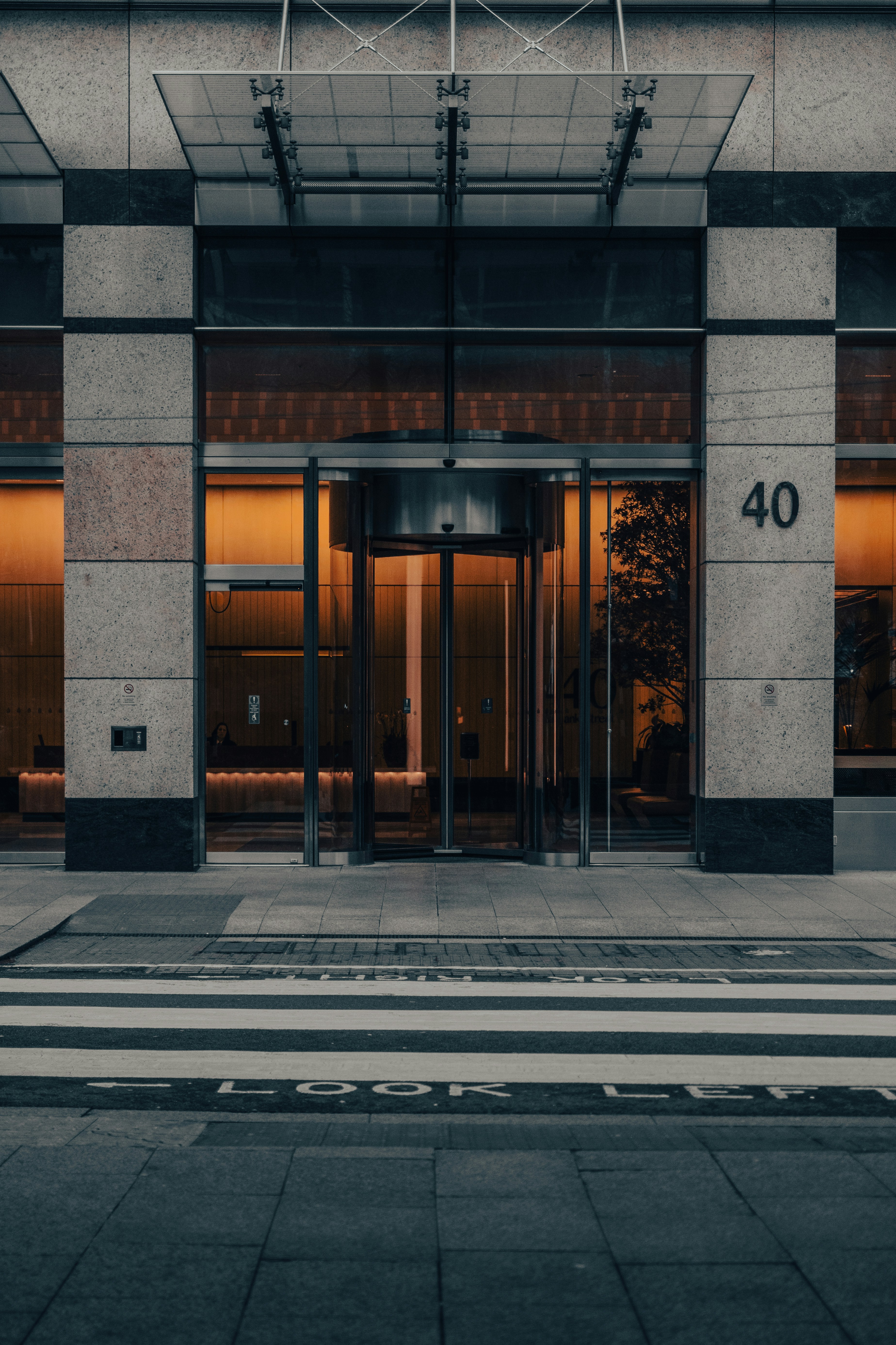Modern building entrance with revolving door and number 40