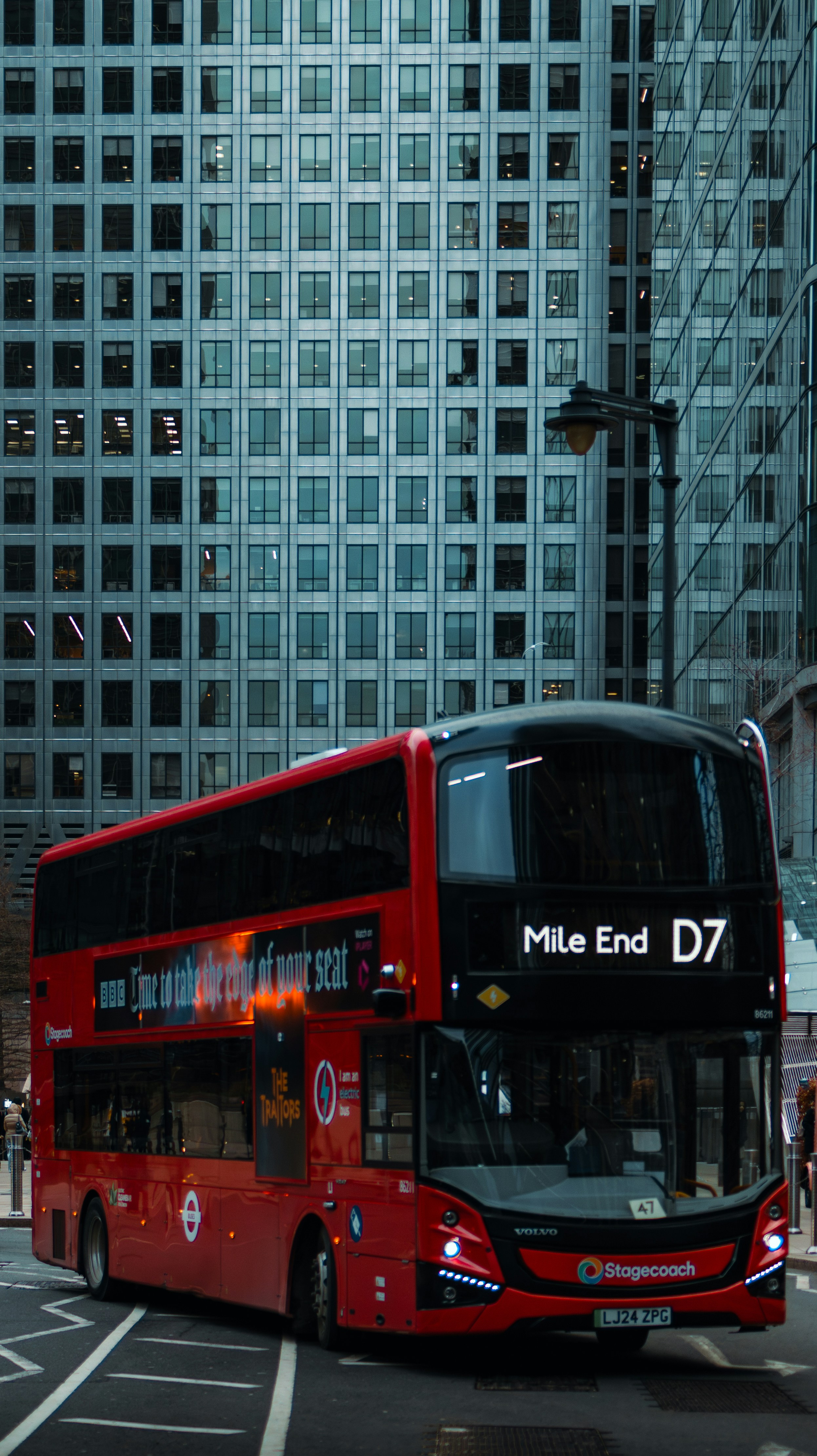 Red double-decker bus on a city street