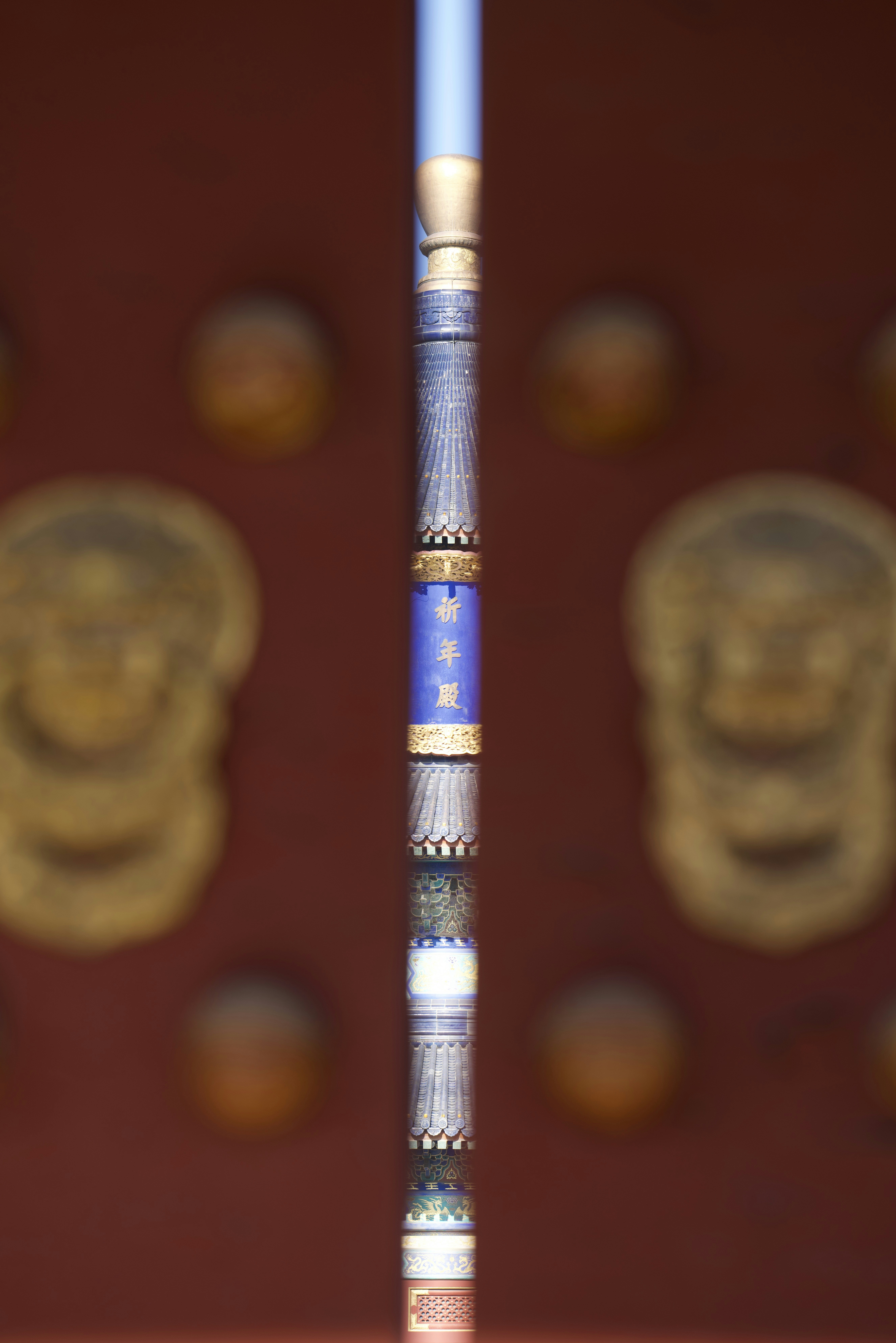 Detailed traditional chinese architectural element with ornate door knockers.