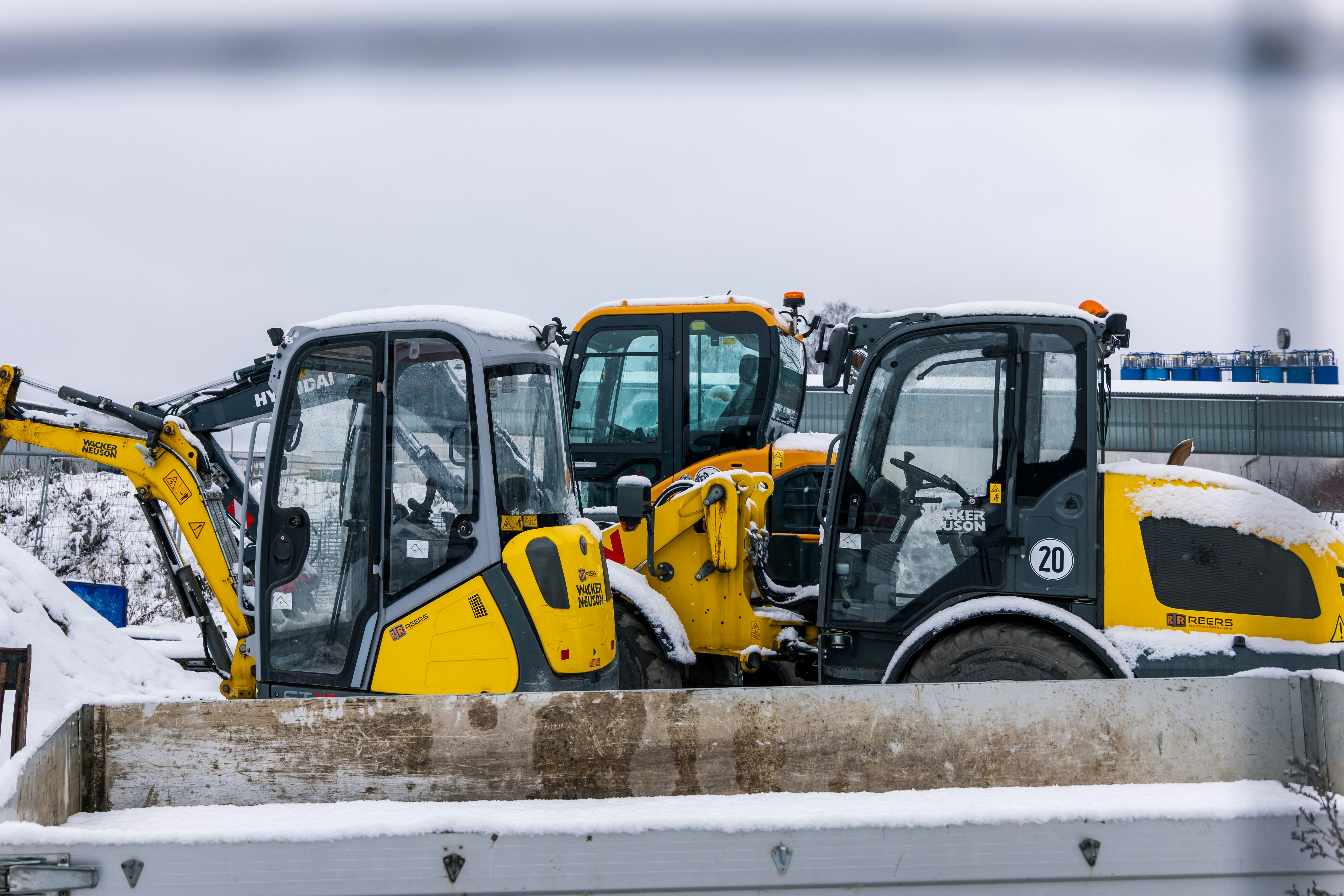 Construction vehicles parked in the snow
