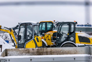 Construction vehicles parked in the snow