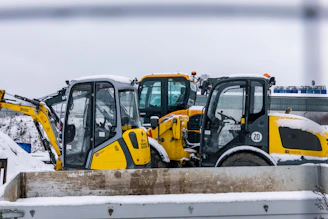 Construction vehicles parked in the snow