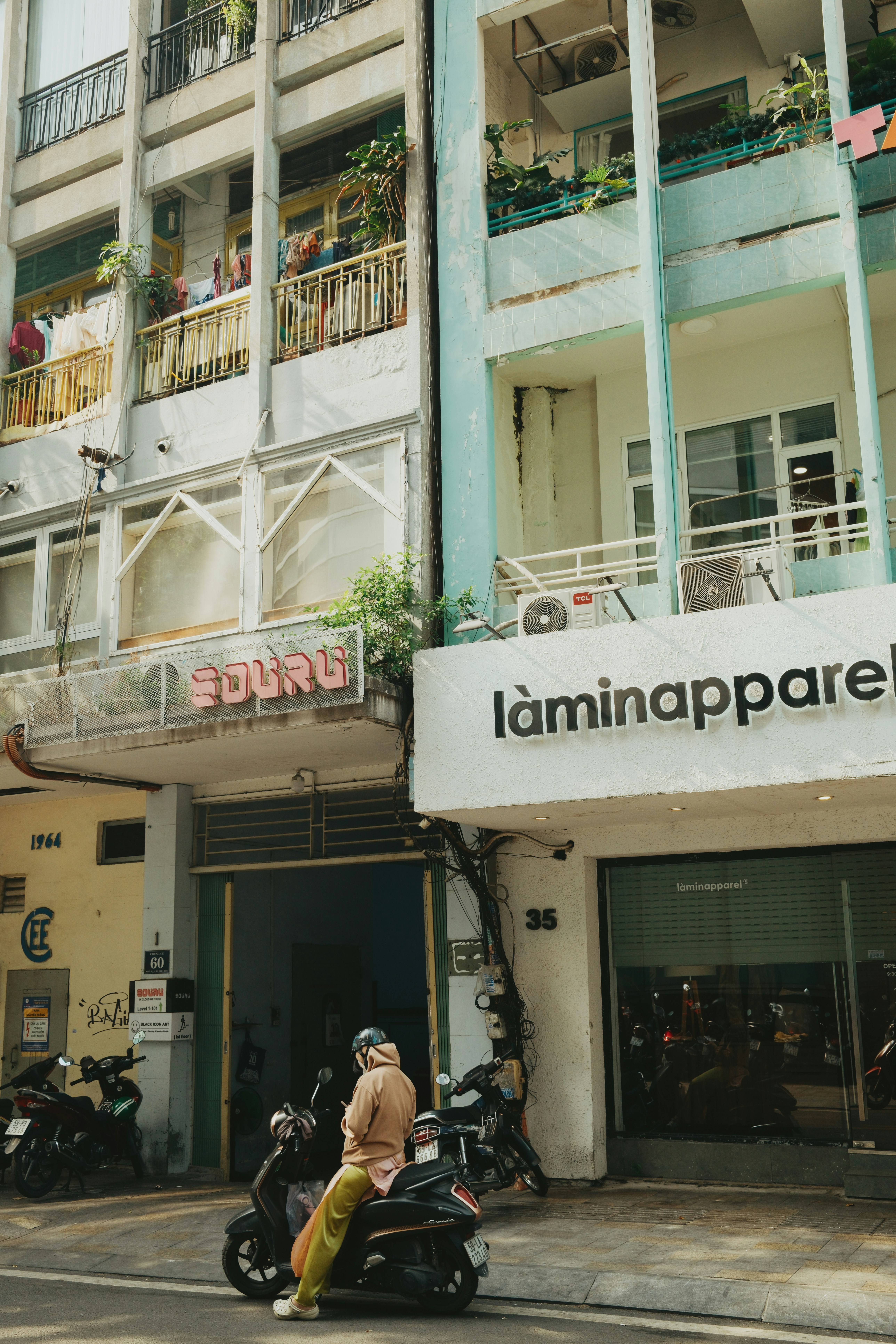 Person on scooter parked on city street.
