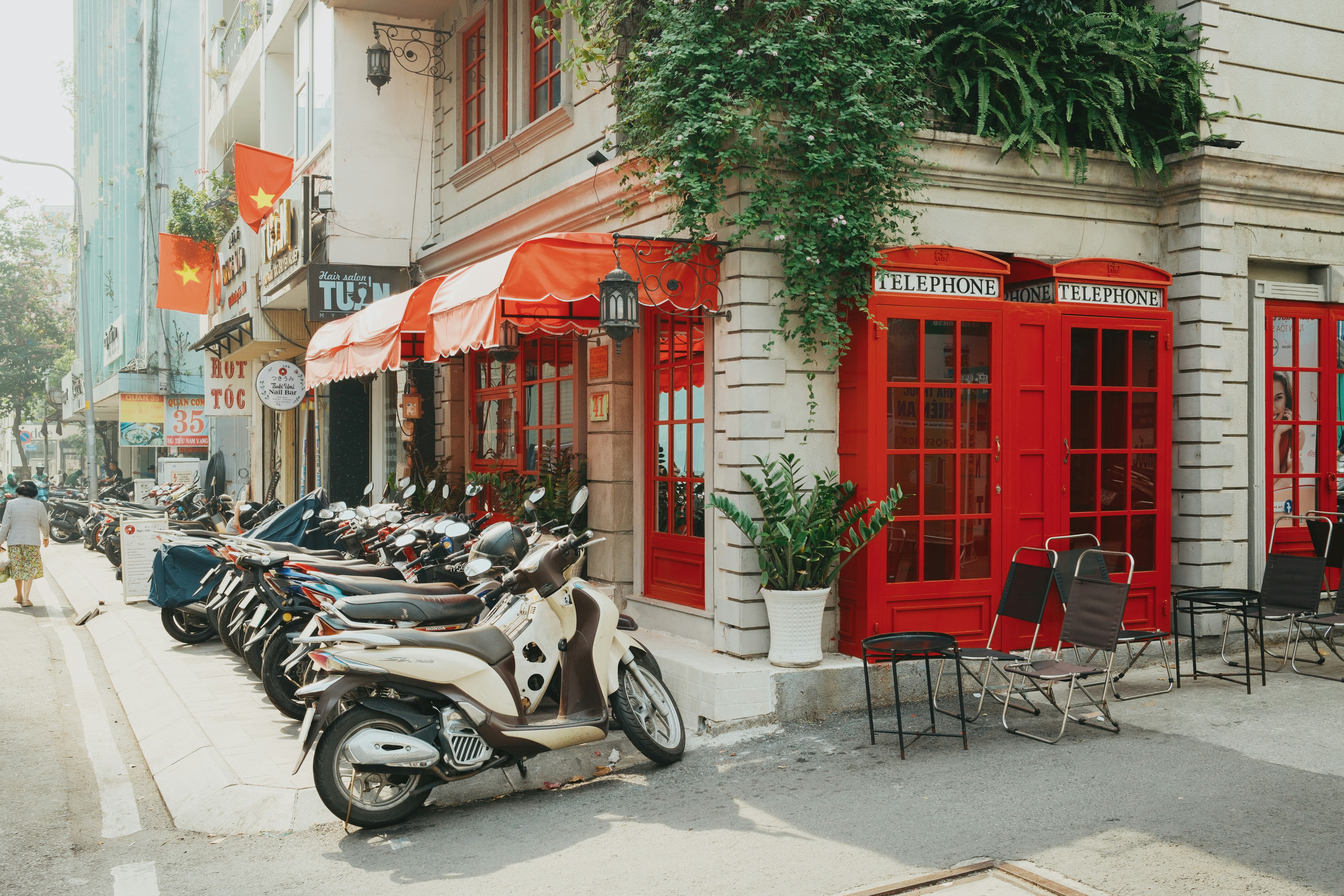 Motorcycles parked outside a cafe with red doors.