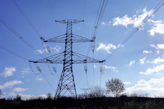 A tall transmission tower against a blue sky.