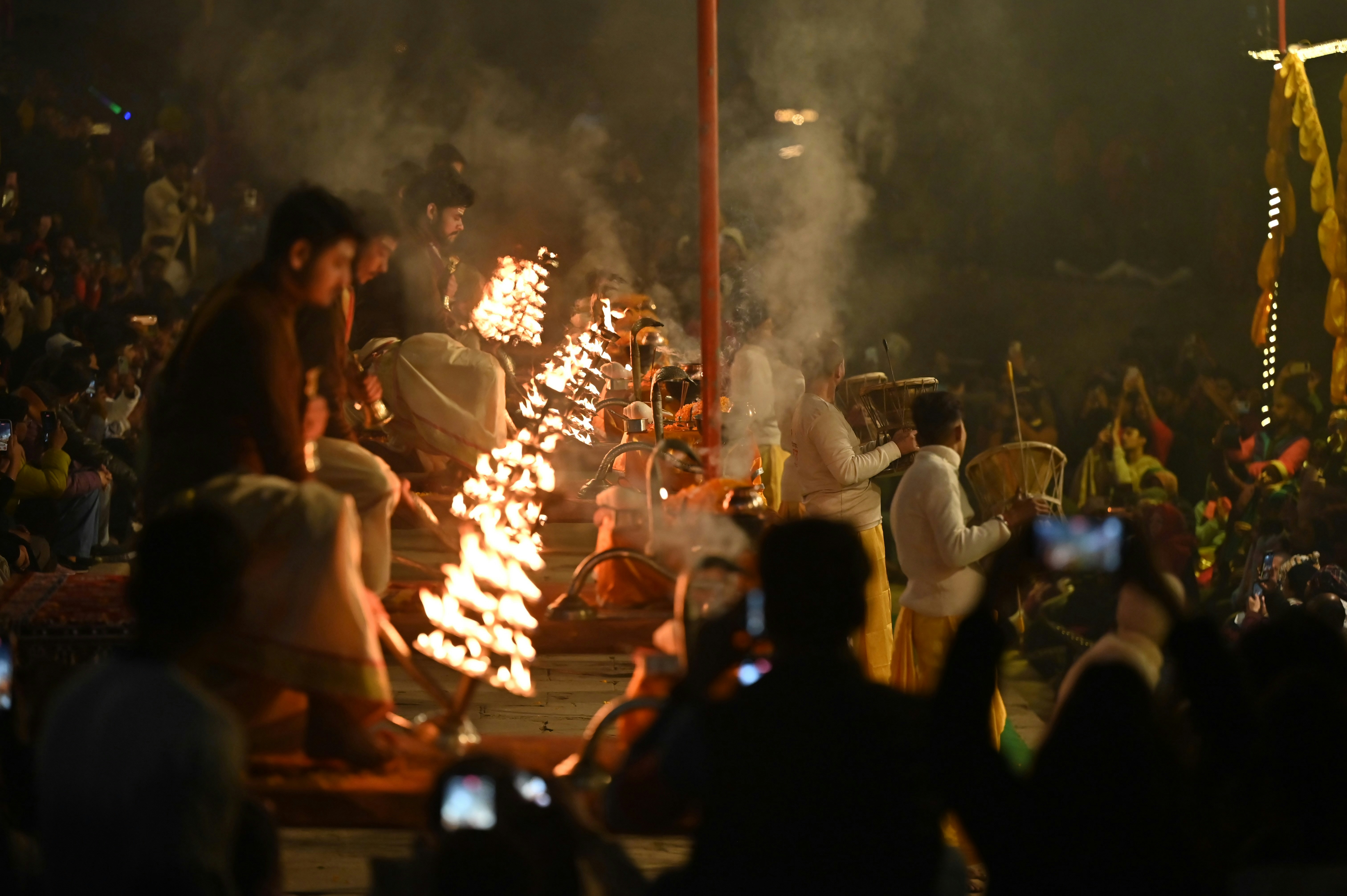 People watching a fire ritual at night
