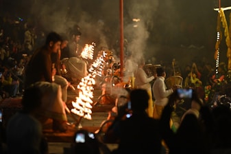 People watching a fire ritual at night