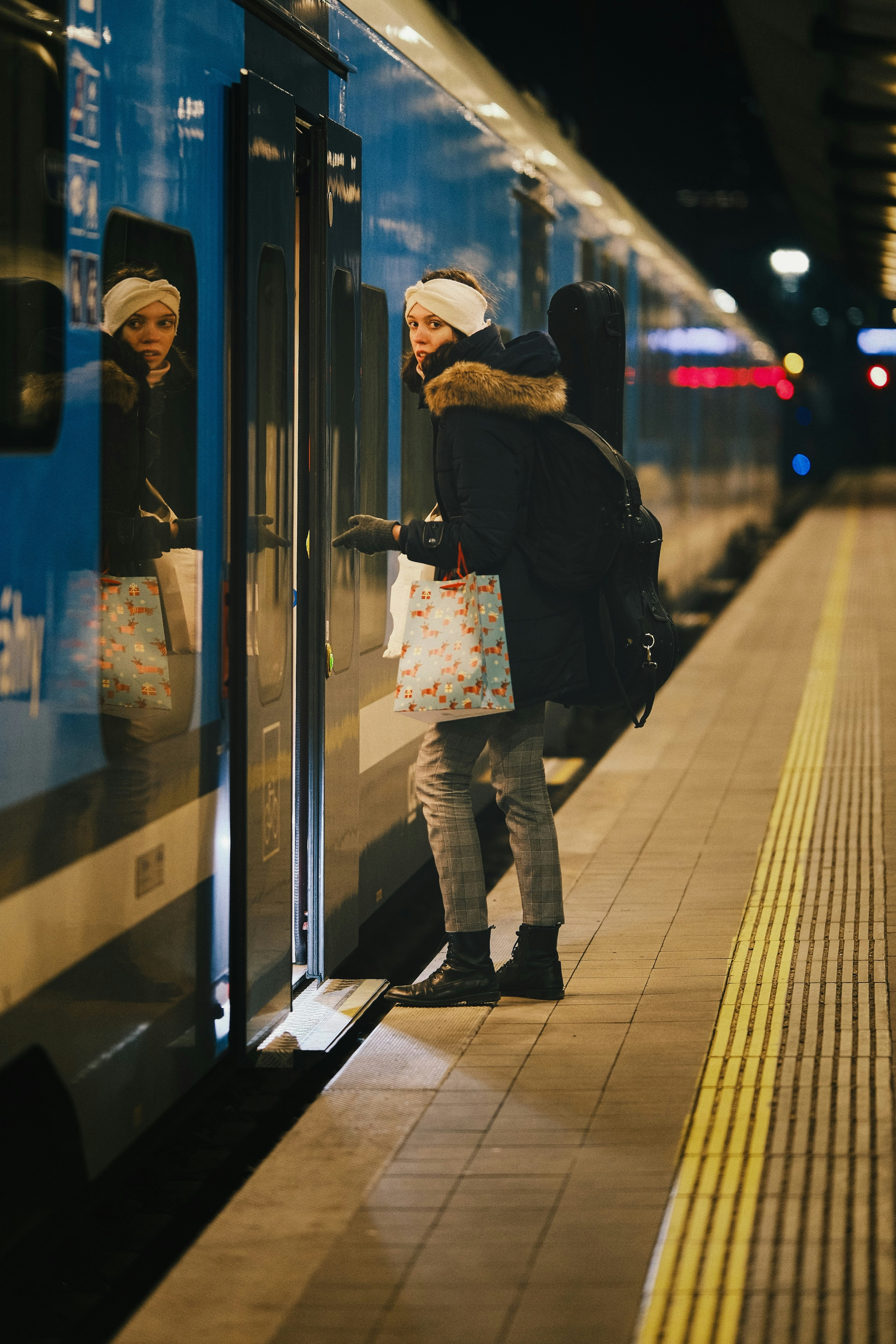Woman boarding a train at a station