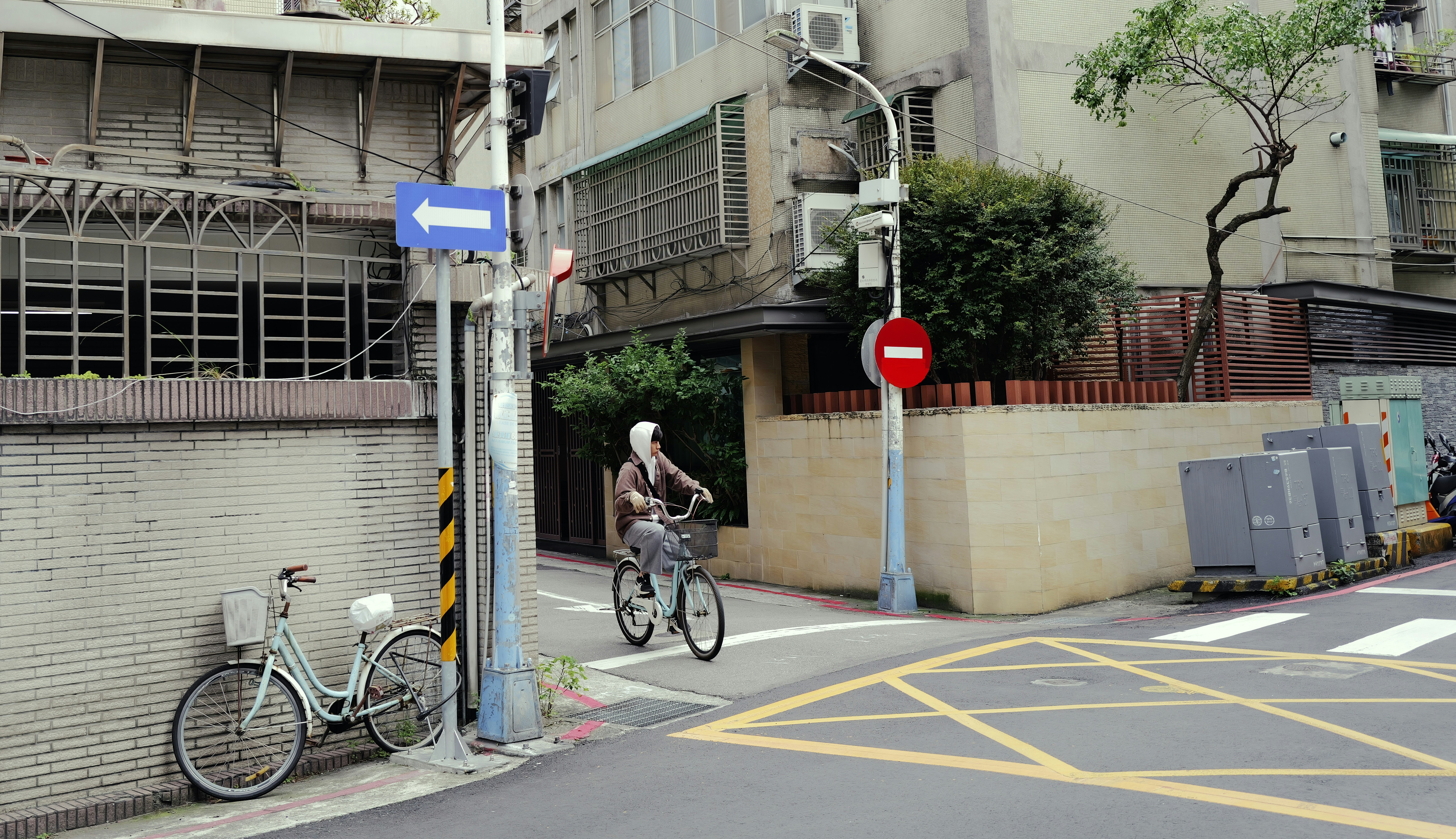 Person rides bicycle down a city street.