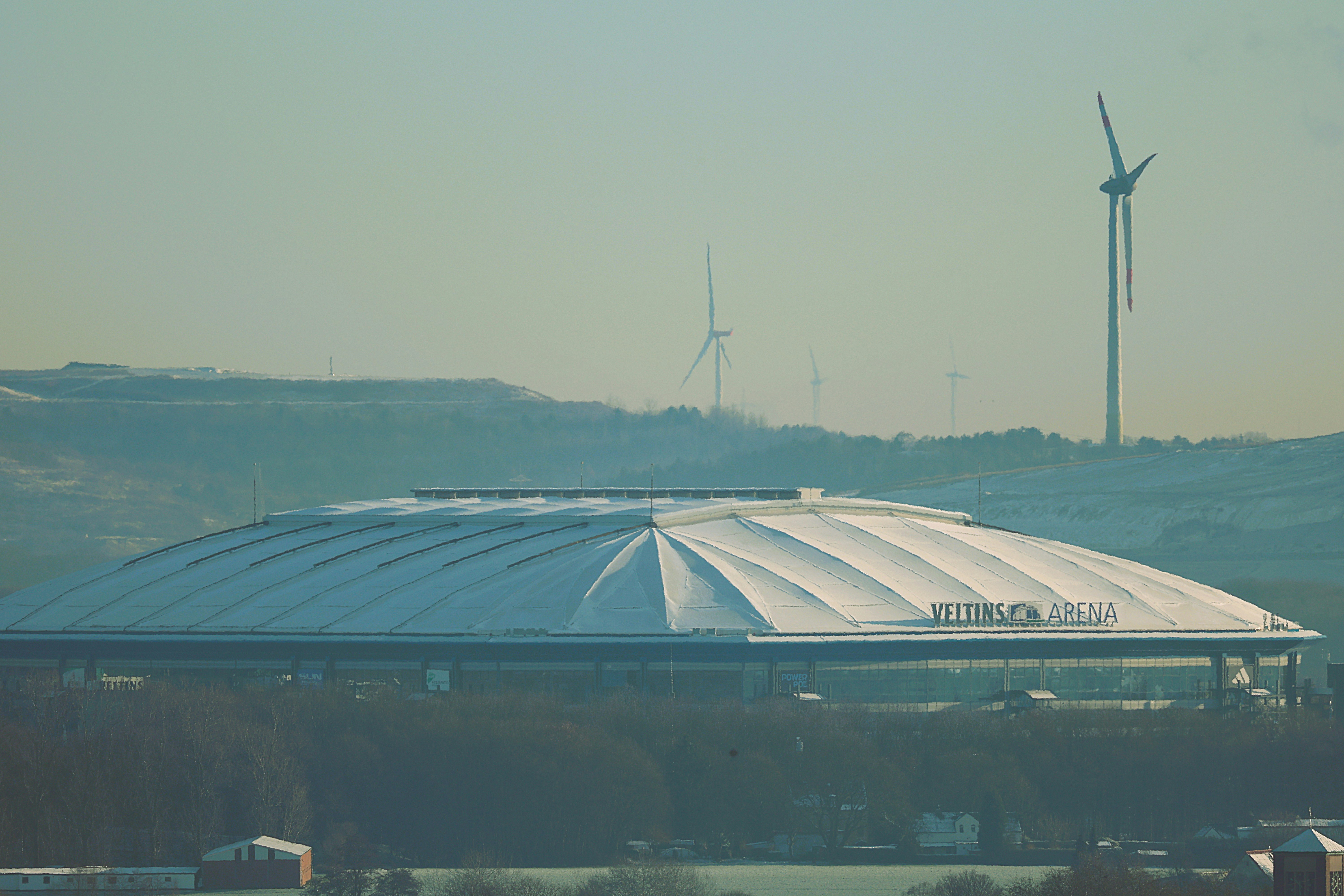 Modern stadium with wind turbines