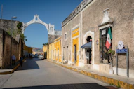 Colonial street with arch and mexican flag