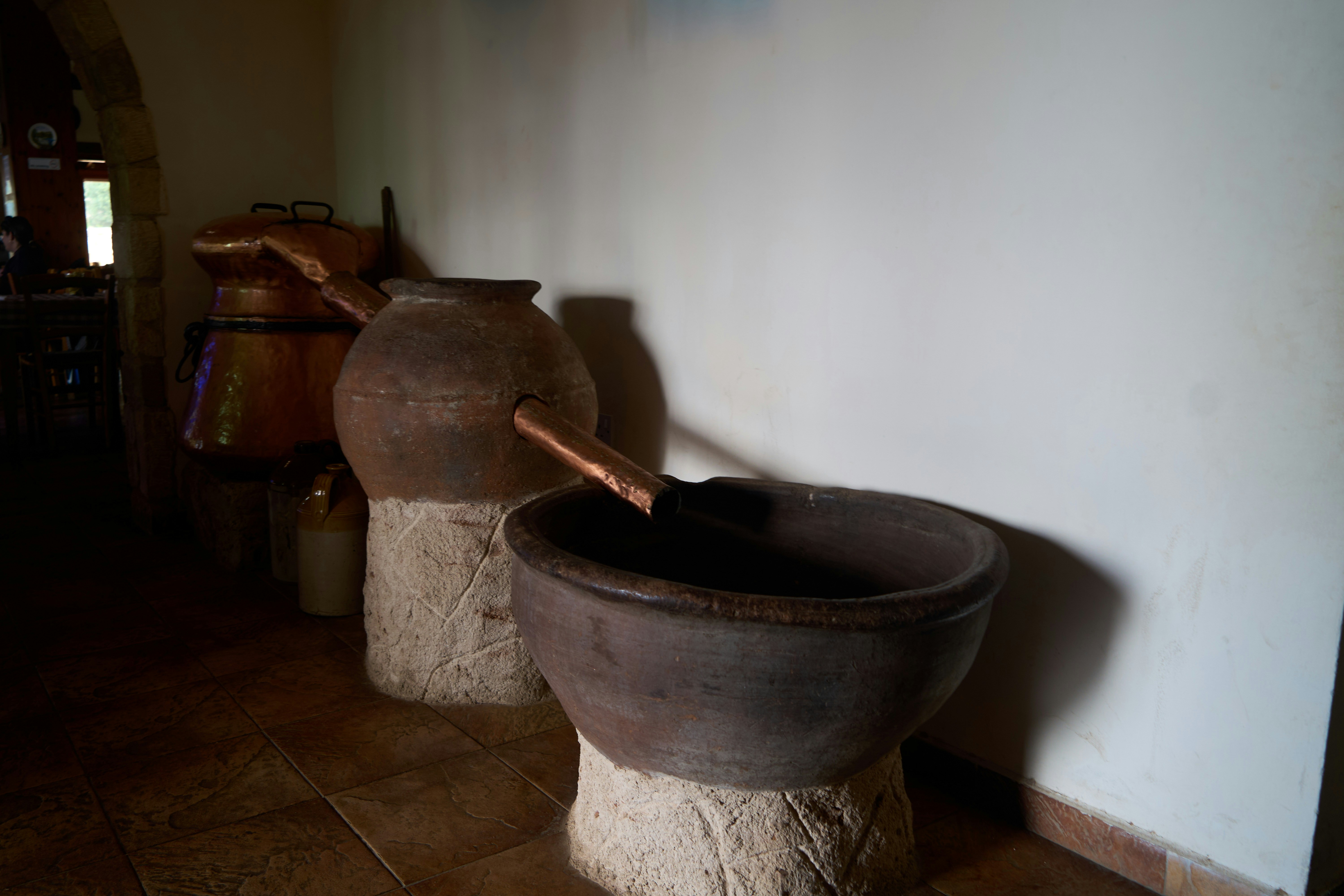 Two old clay pots on stone pedestals.