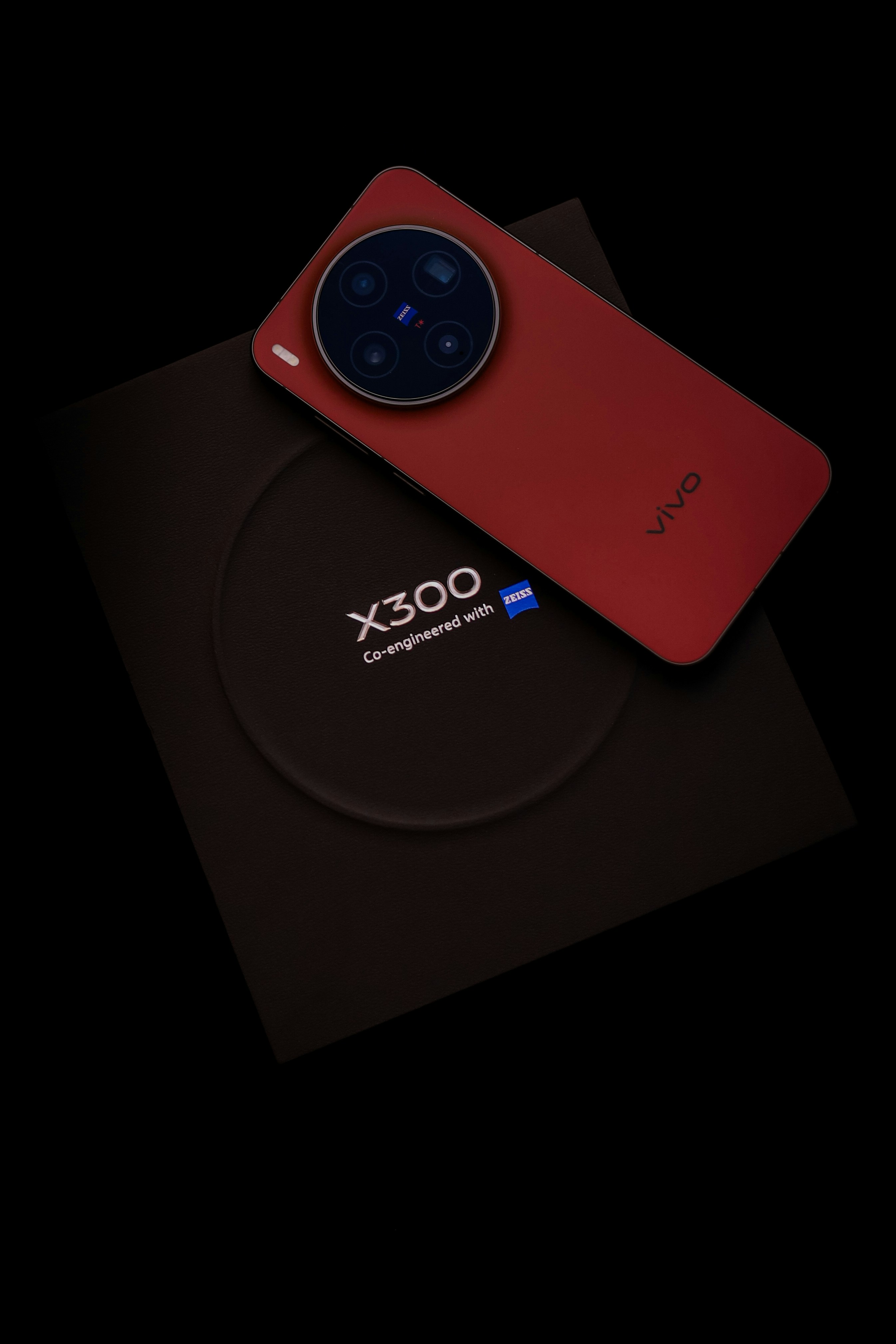 Red smartphone with camera module on box