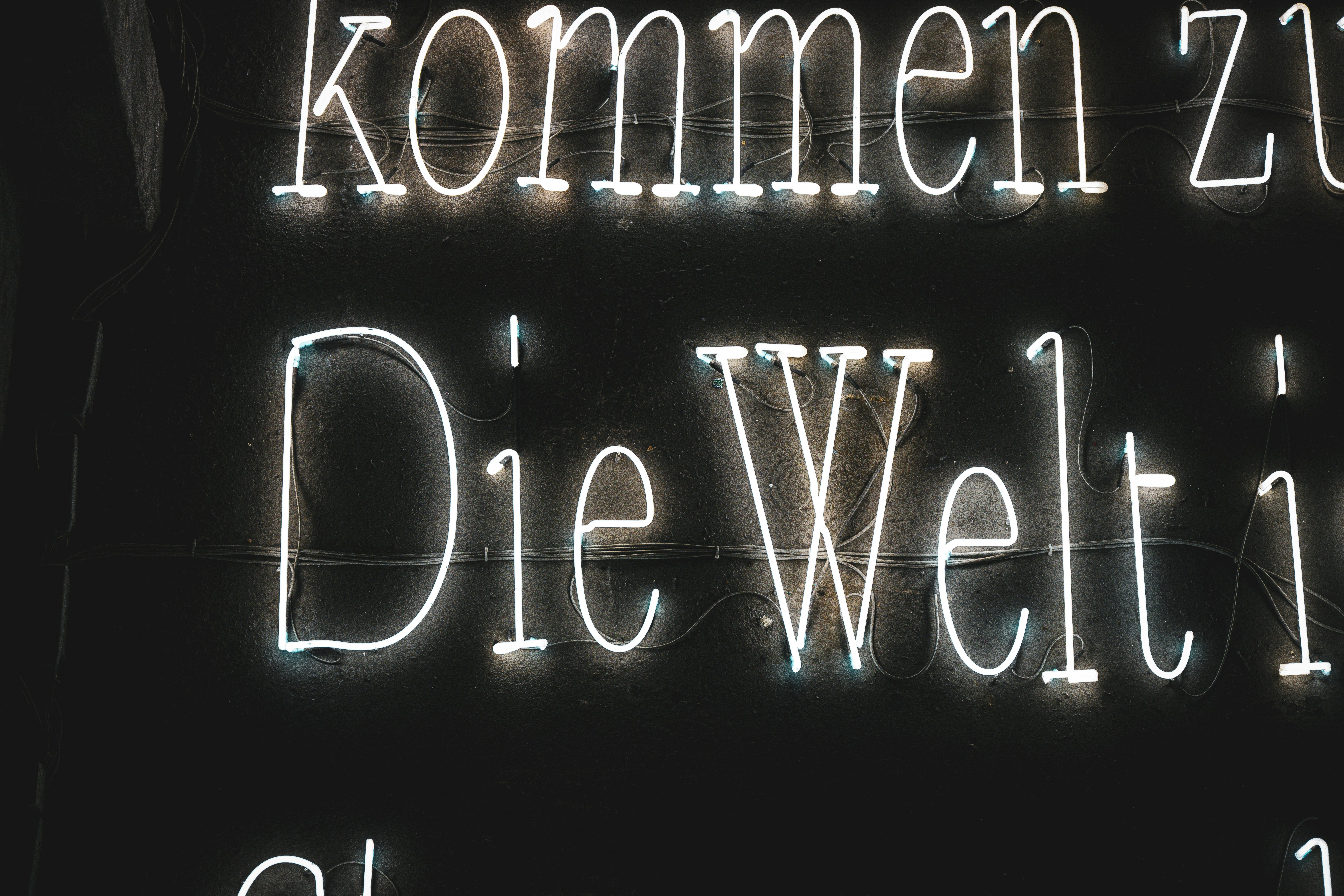 White neon text on black background