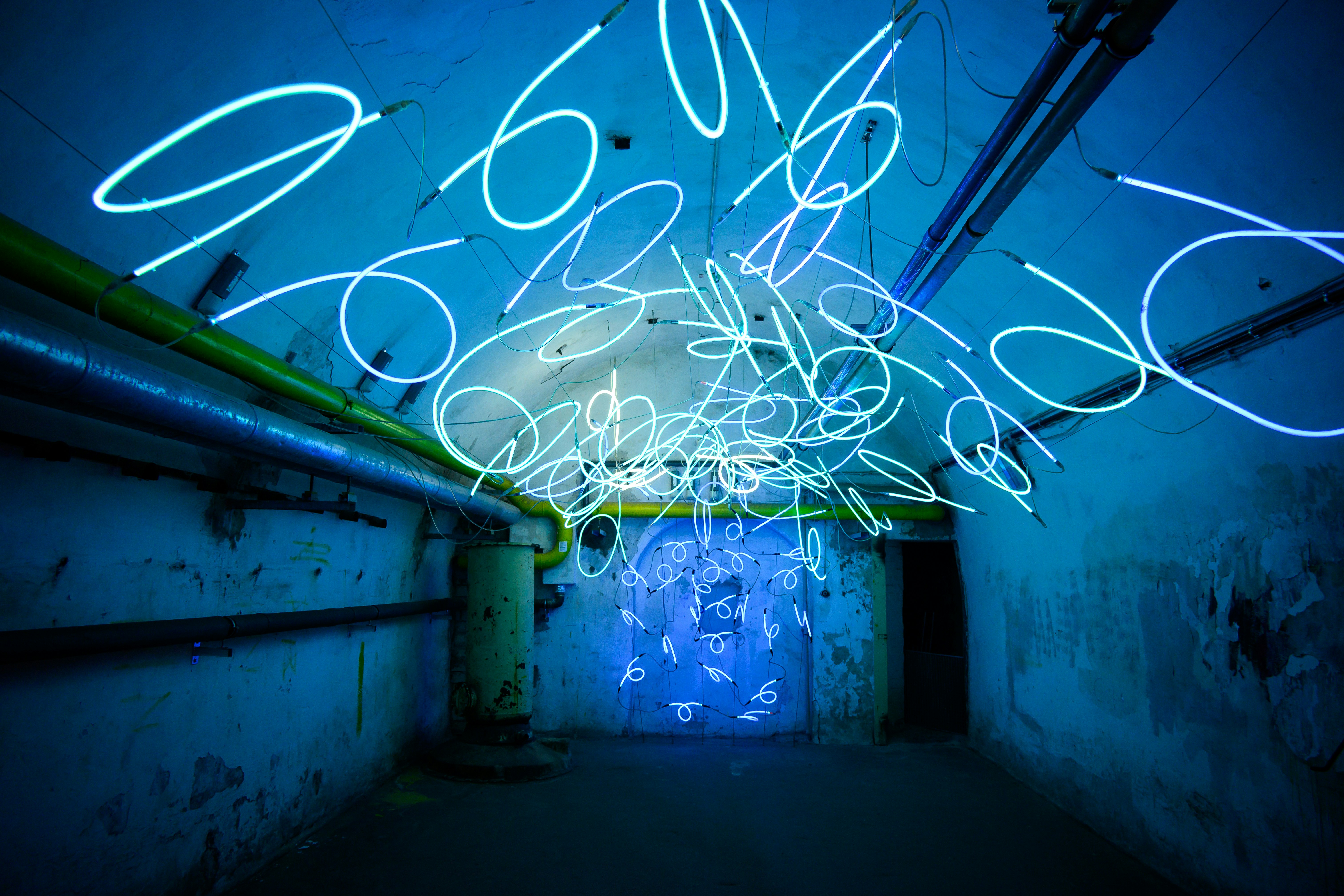 Abstract blue light installation in dark tunnel