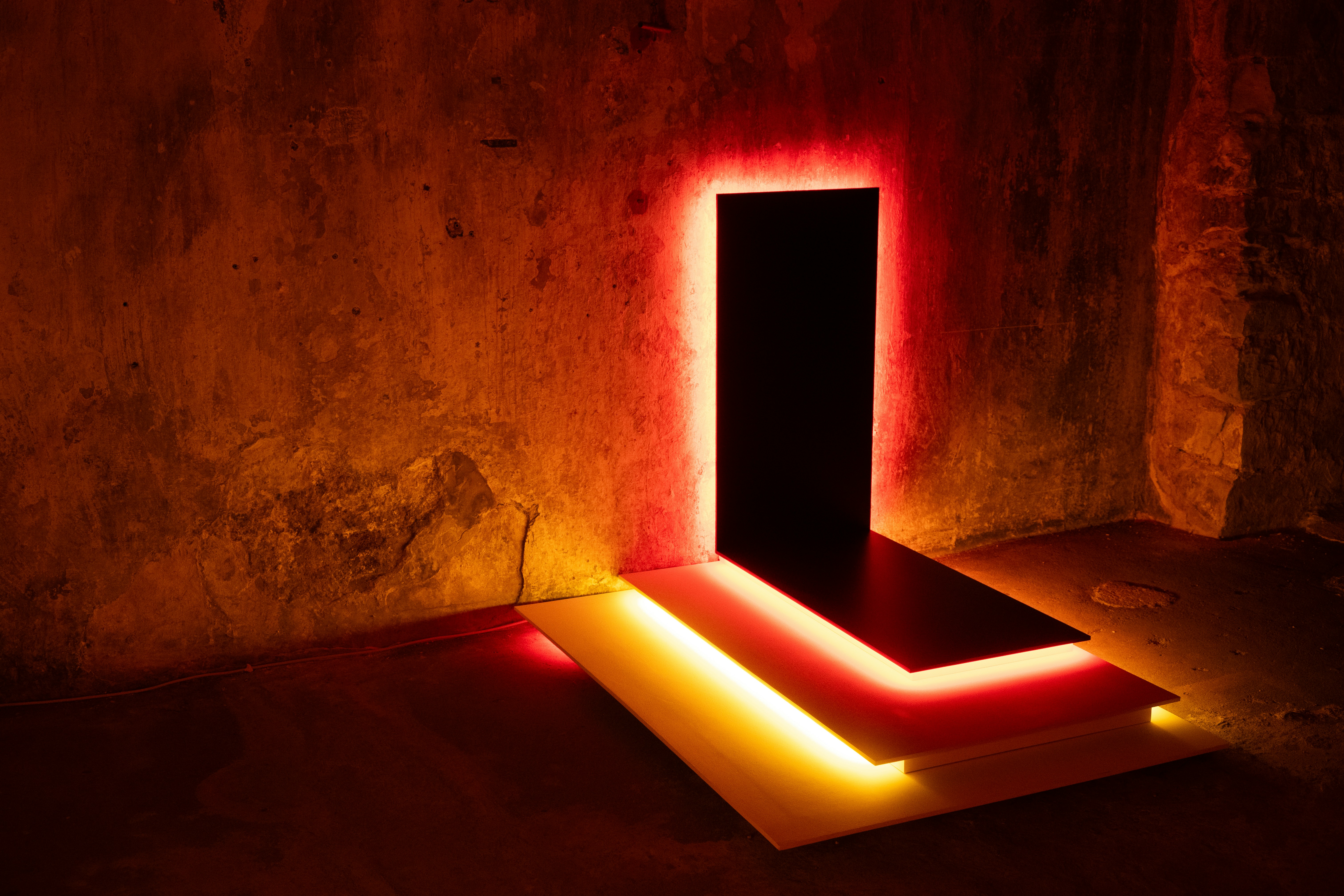 A dark doorway outlined by red and yellow light