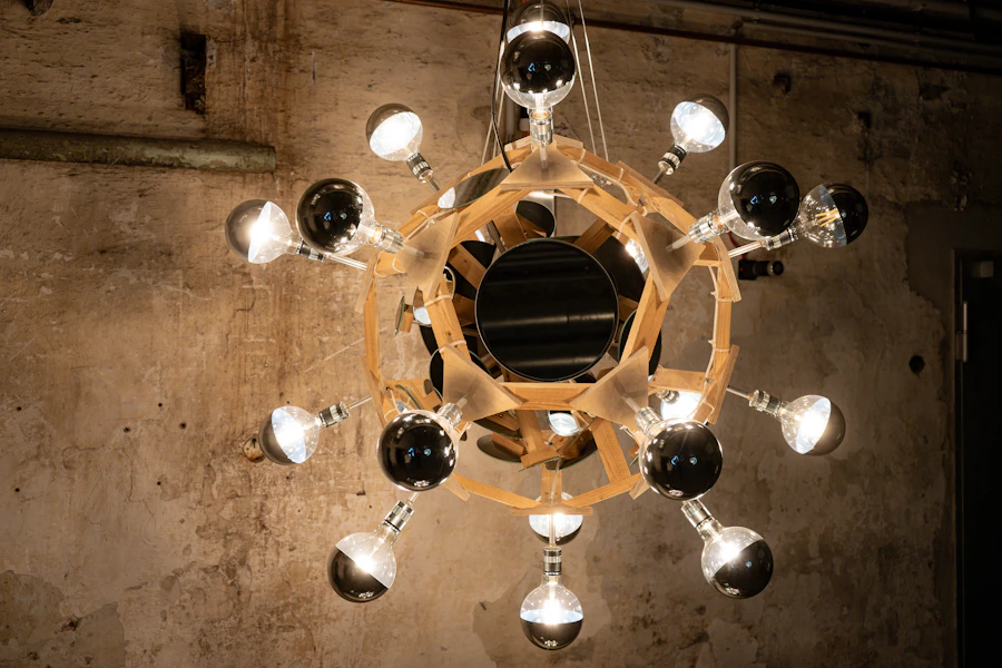 A round chandelier of bare bulbs in a concrete room