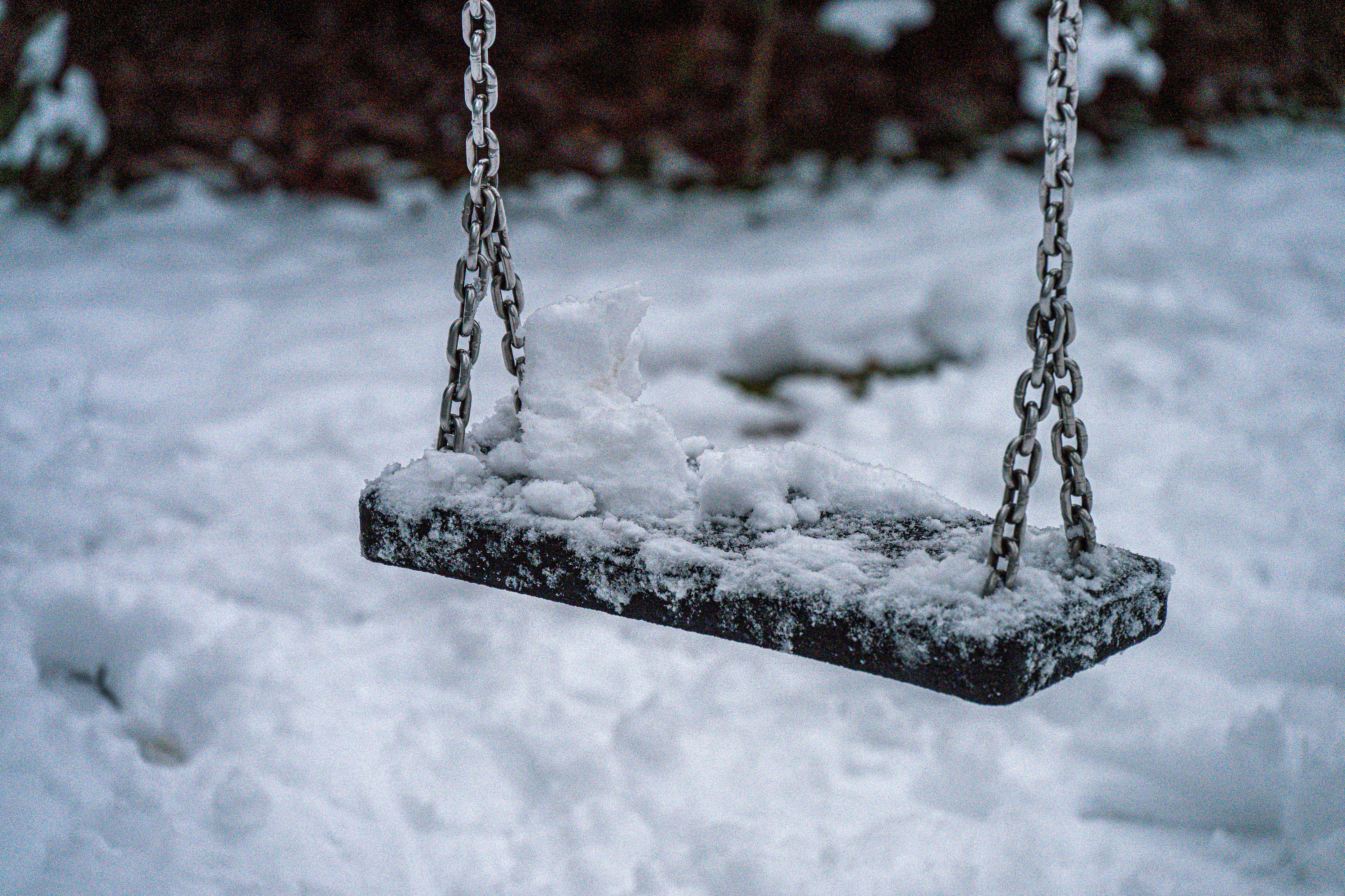 A snow-covered swing set in winter