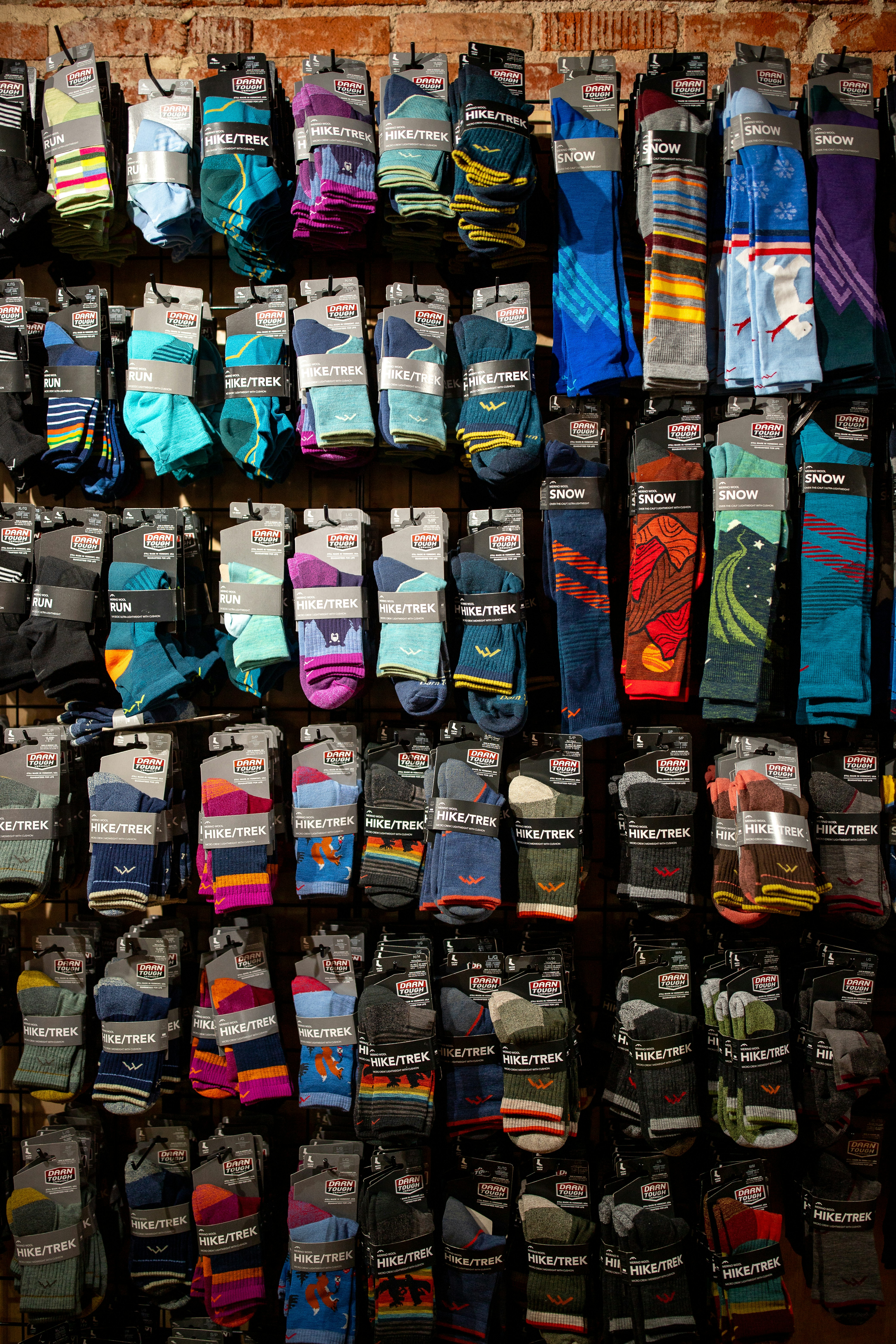Wall display of colorful socks with various patterns.