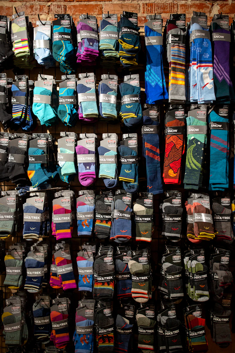 A rack stacked with sporty cushioned athletic socks in many colors