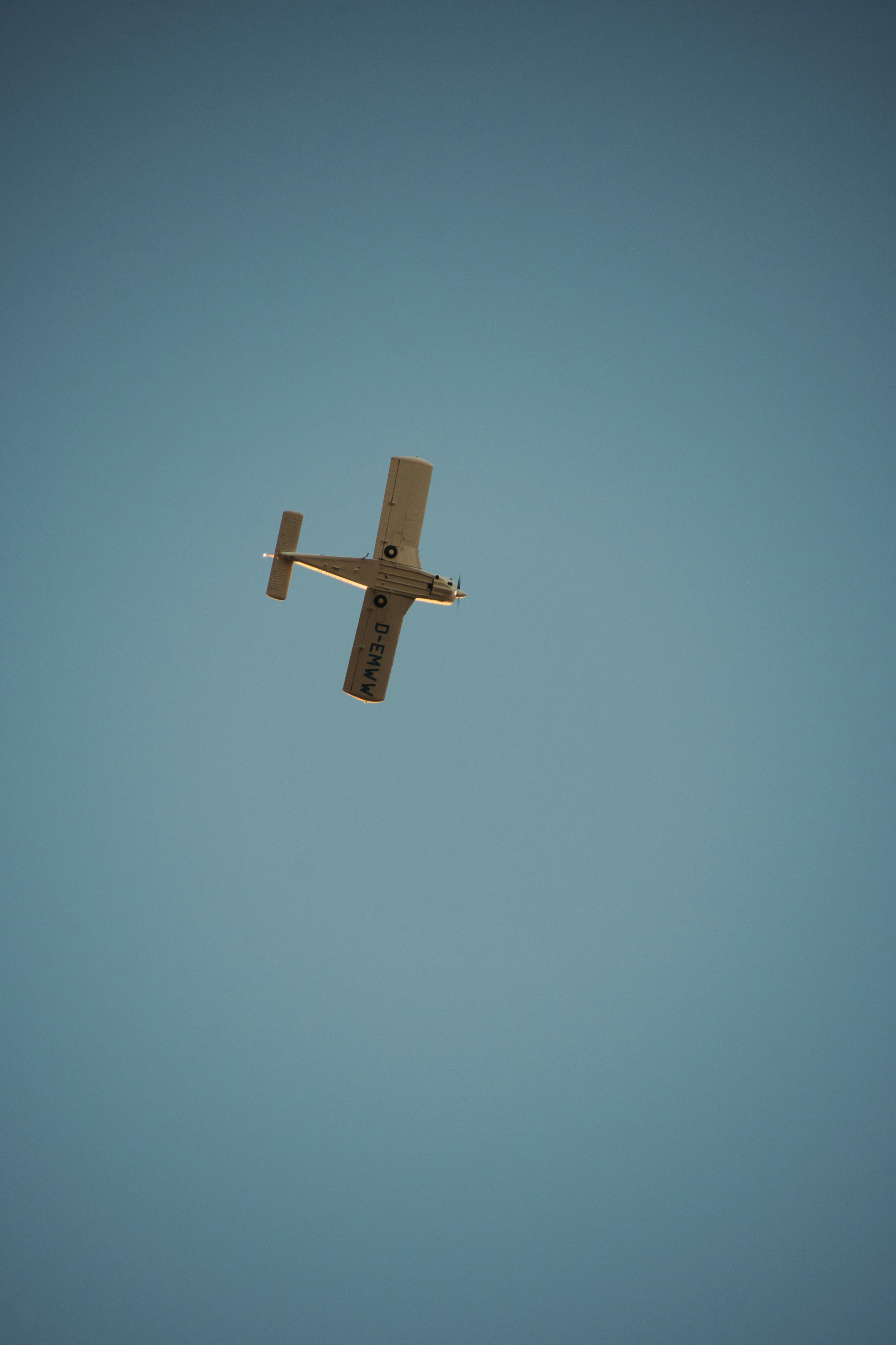 Small airplane flying in a clear blue sky