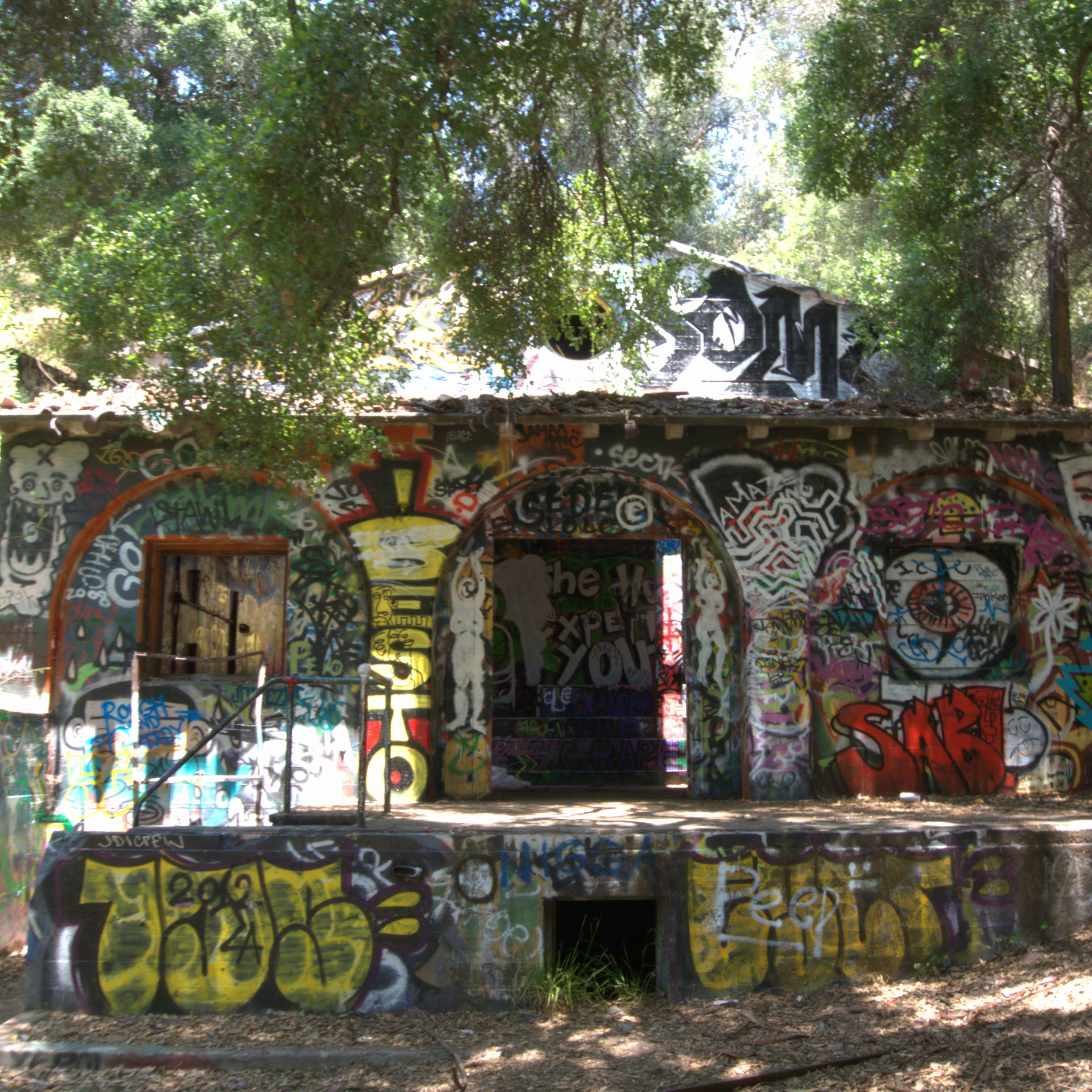 Abandoned building covered in colorful graffiti art