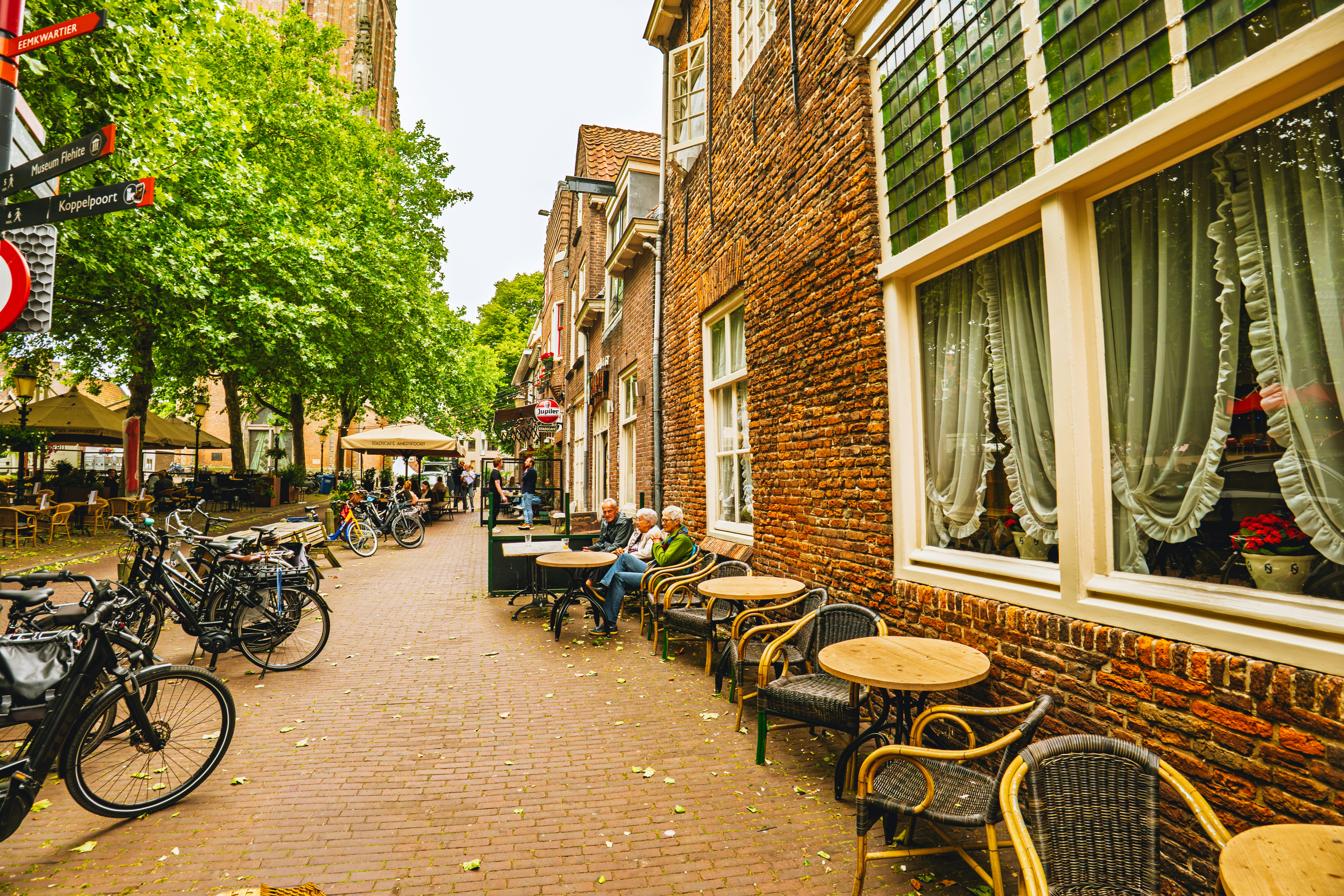 Outdoor cafe seating along a historic European street