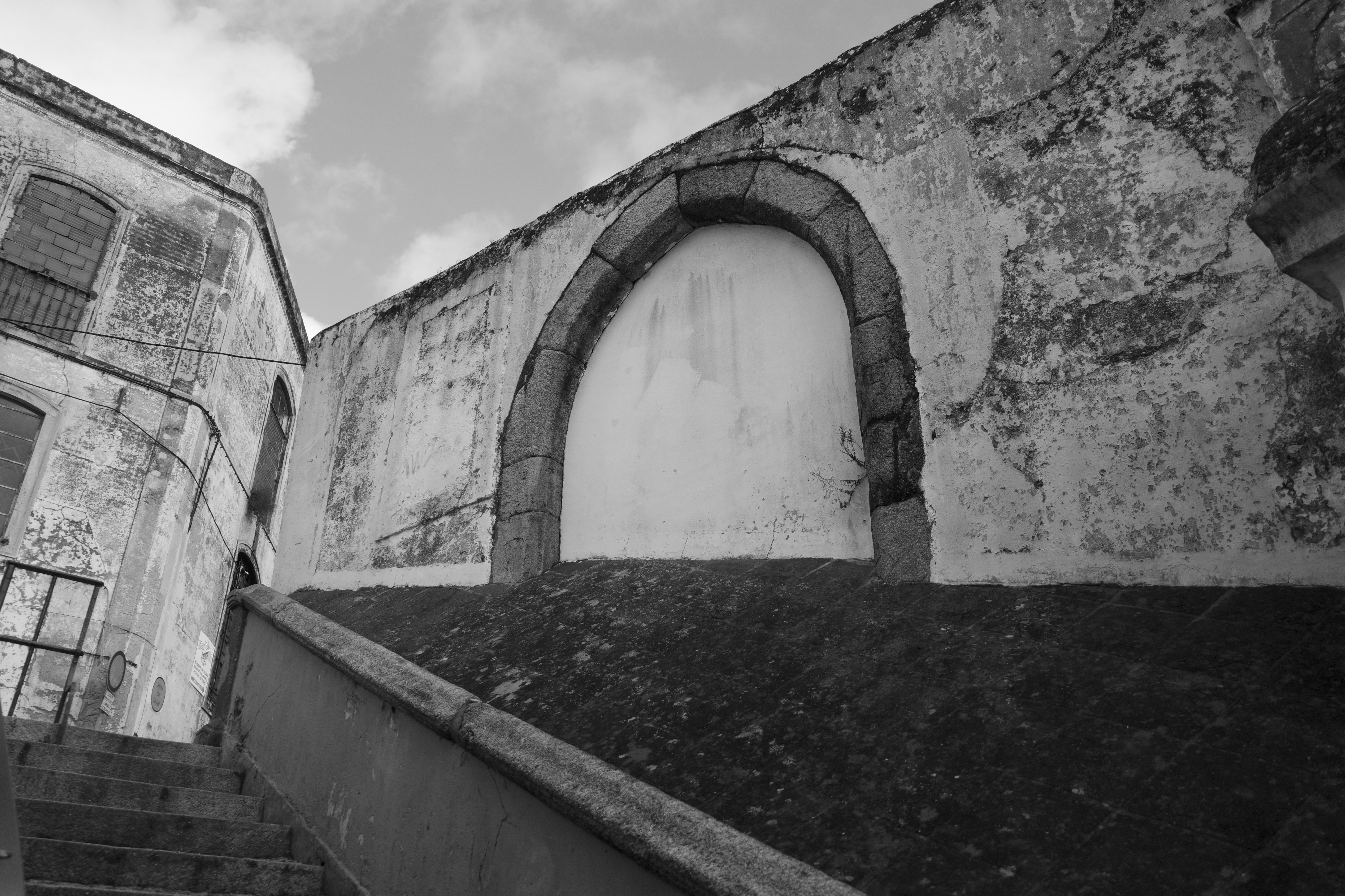 Stone archway on a weathered building exterior wall