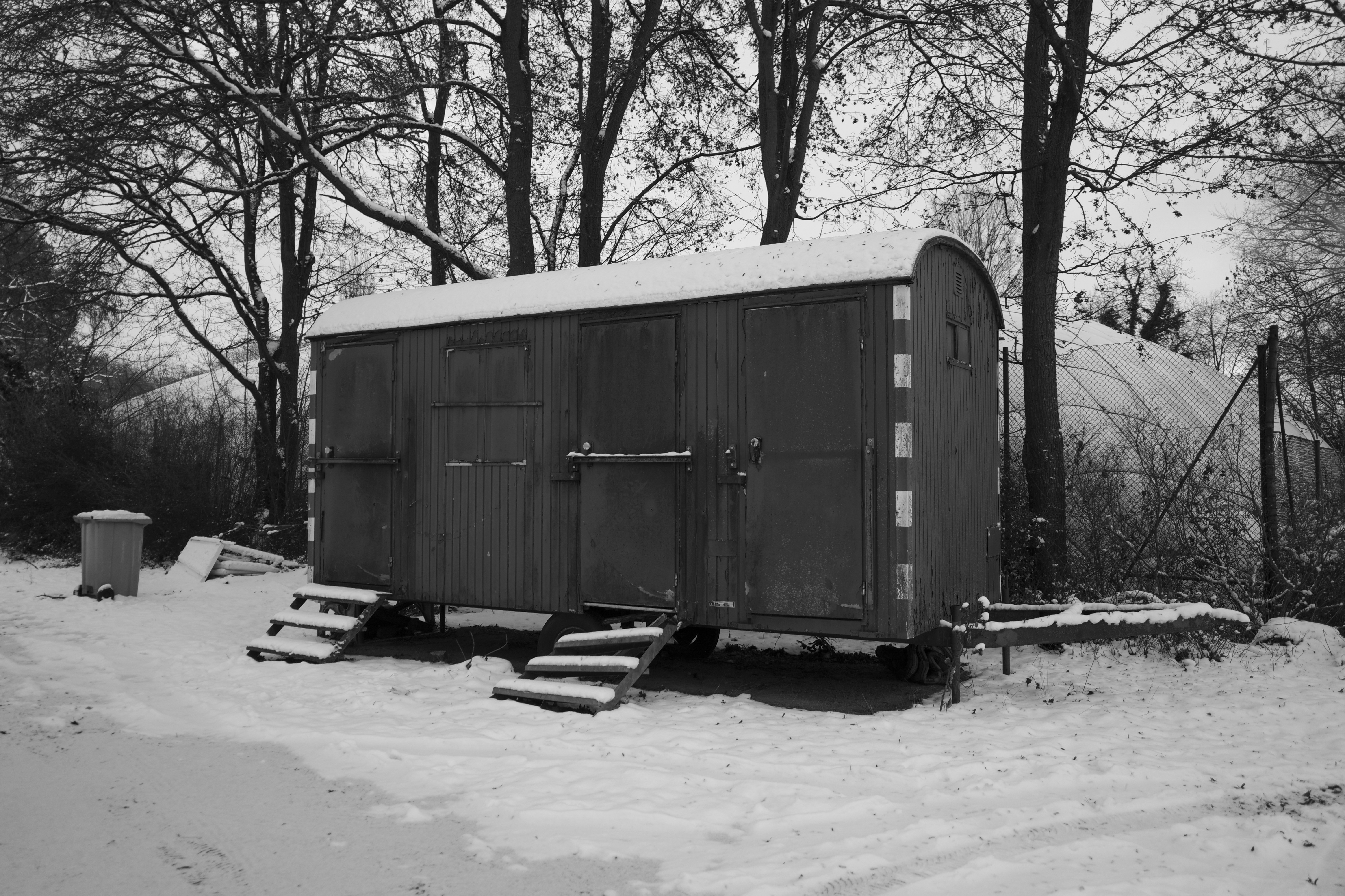 A small trailer sits in the snow.
