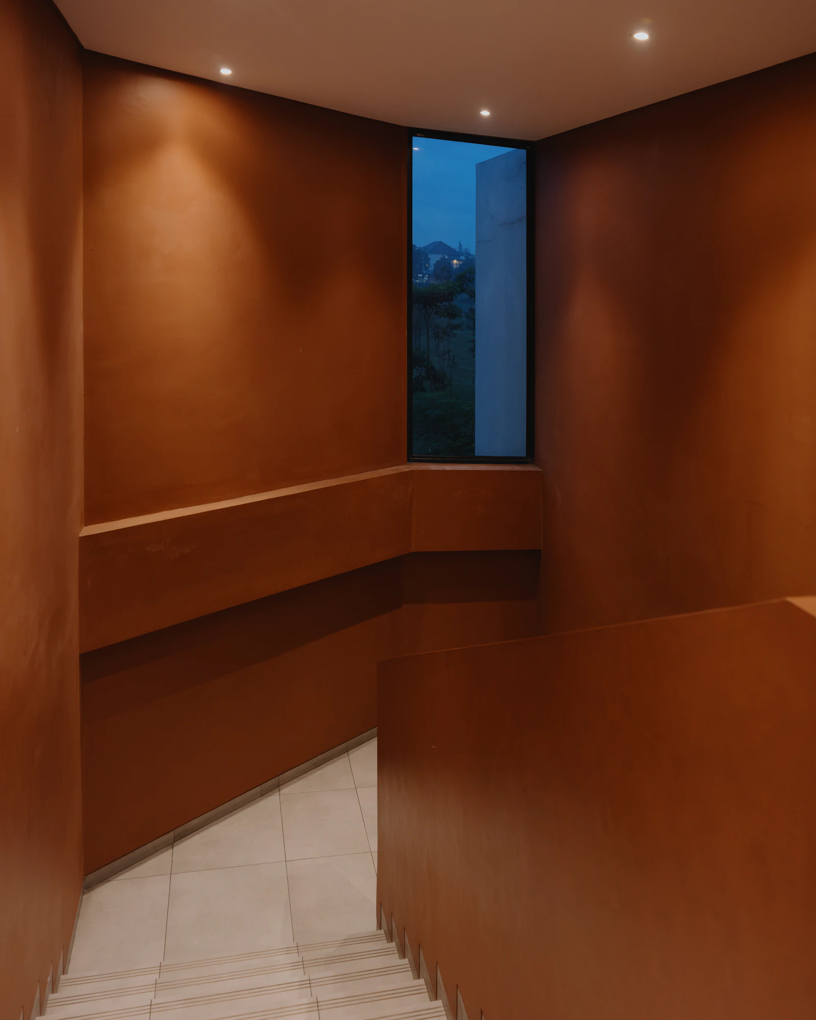 Hand-finished natural plaster wall in a warm neutral tone.
