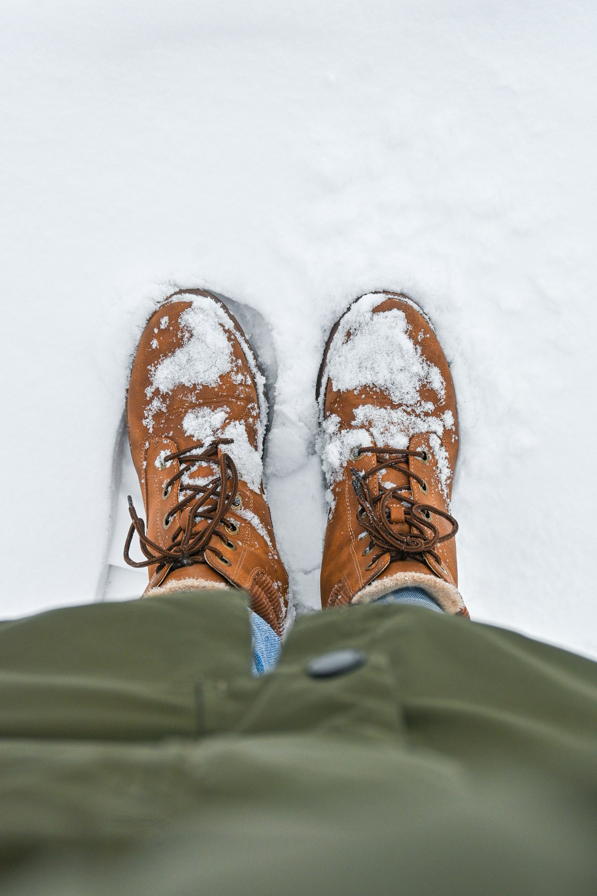 Brown work boots covered in snow - fastest boot dryer for winter