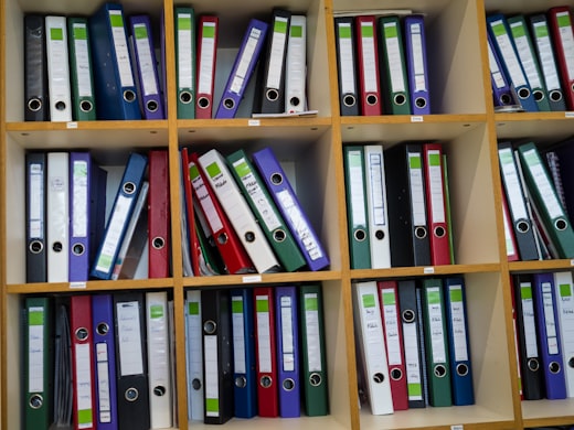 Shelves of colorful organized binders and file folders