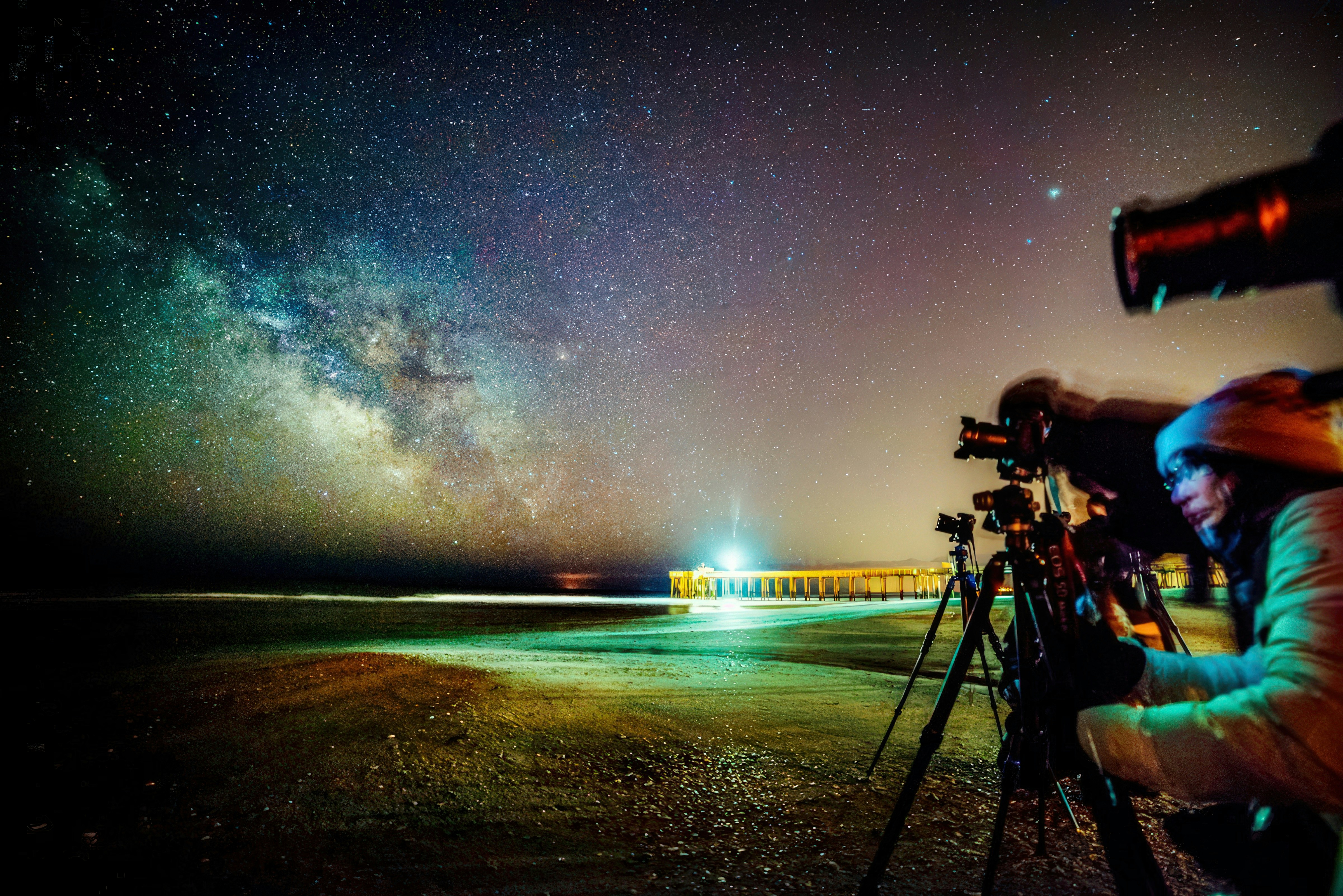 People observing the milky way with telescopes at night.