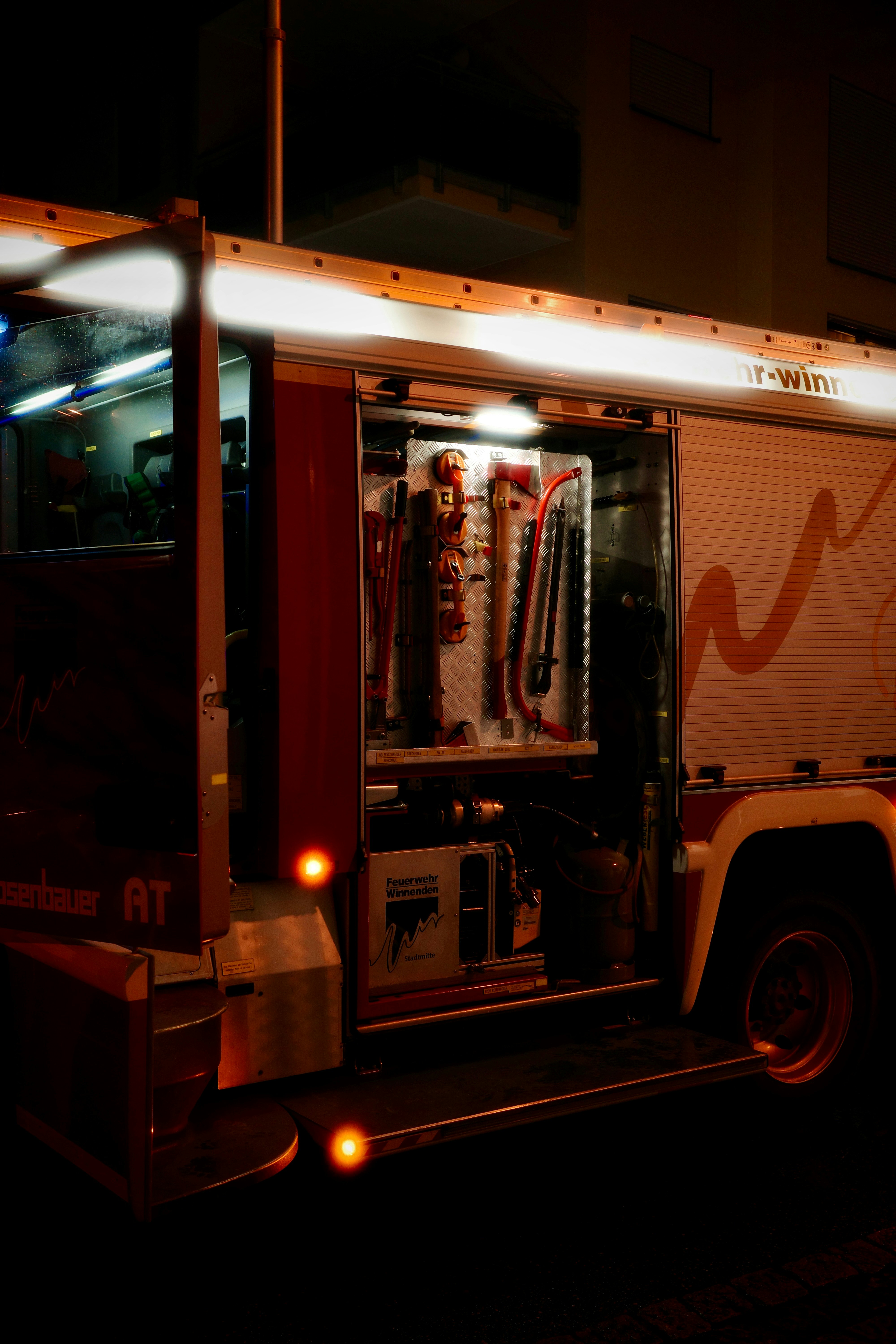 Fire truck with open compartment showing equipment.