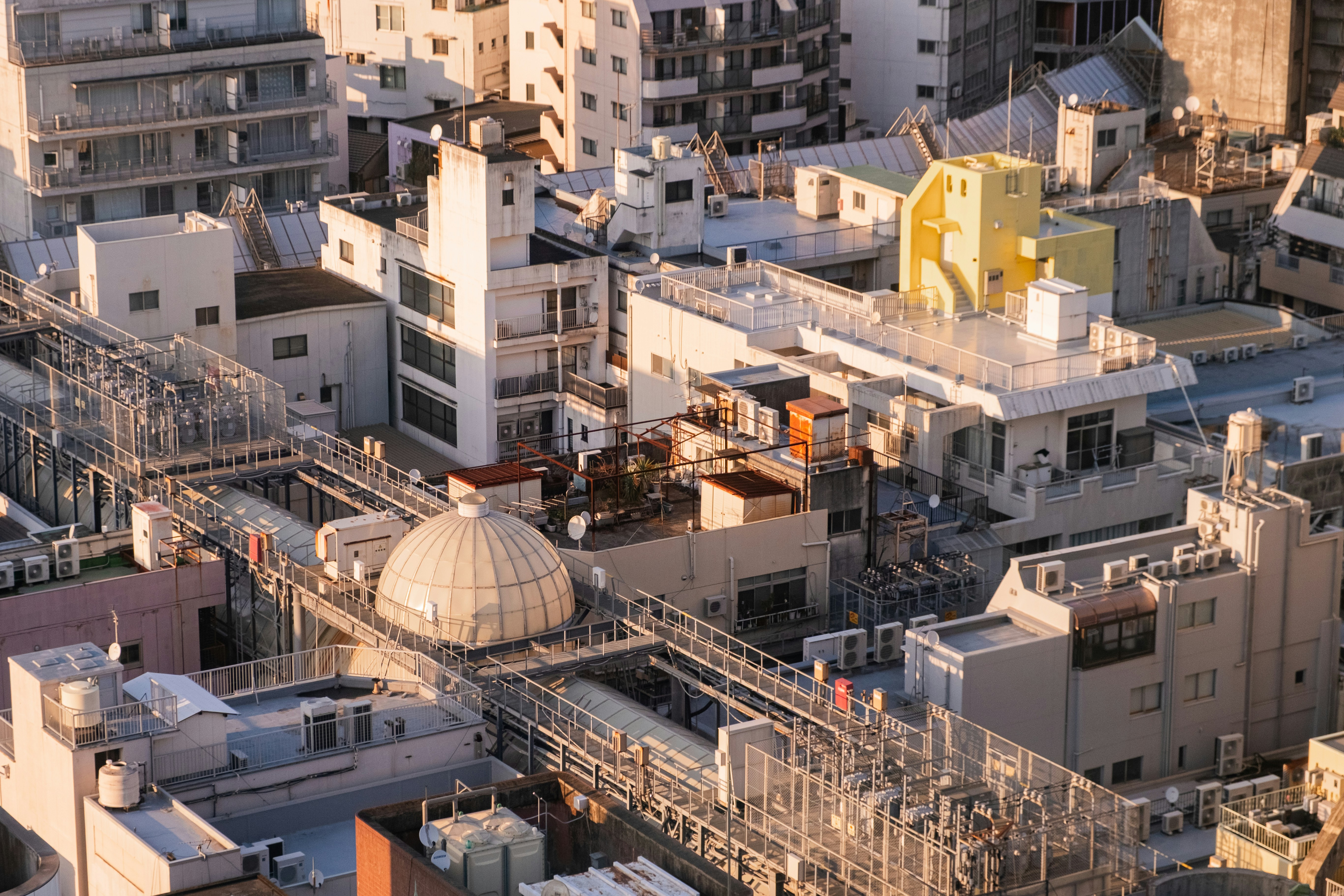 Rooftops of a dense urban cityscape with complex architecture.