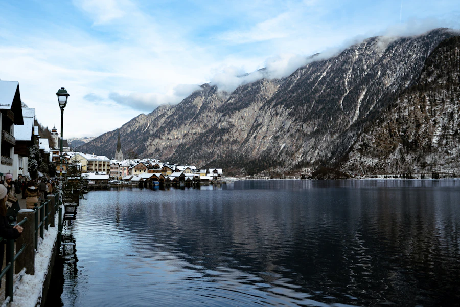 Snowy village of Hallstatt reflected in the lake with Austrian Alps behind